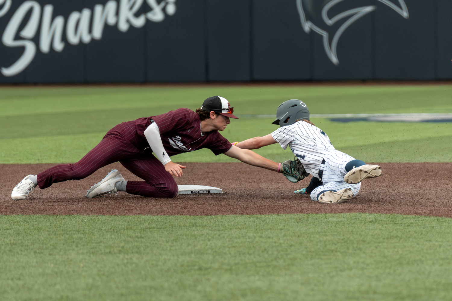 East Hampton shortstop Hudson Meyer tags out an ESM base runner trying to steal second base.   RON ESPOSITO