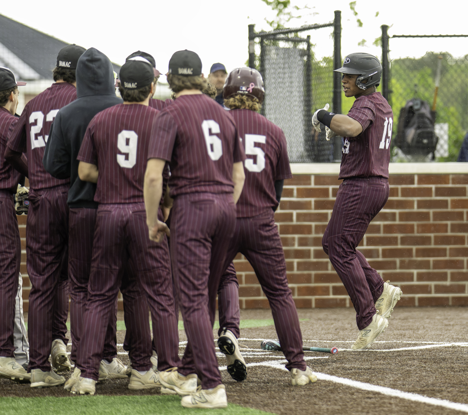 Victoreddy Aguero is greeted at home after his two-run home run in the first inning on Friday. MARIANNE BARNETT