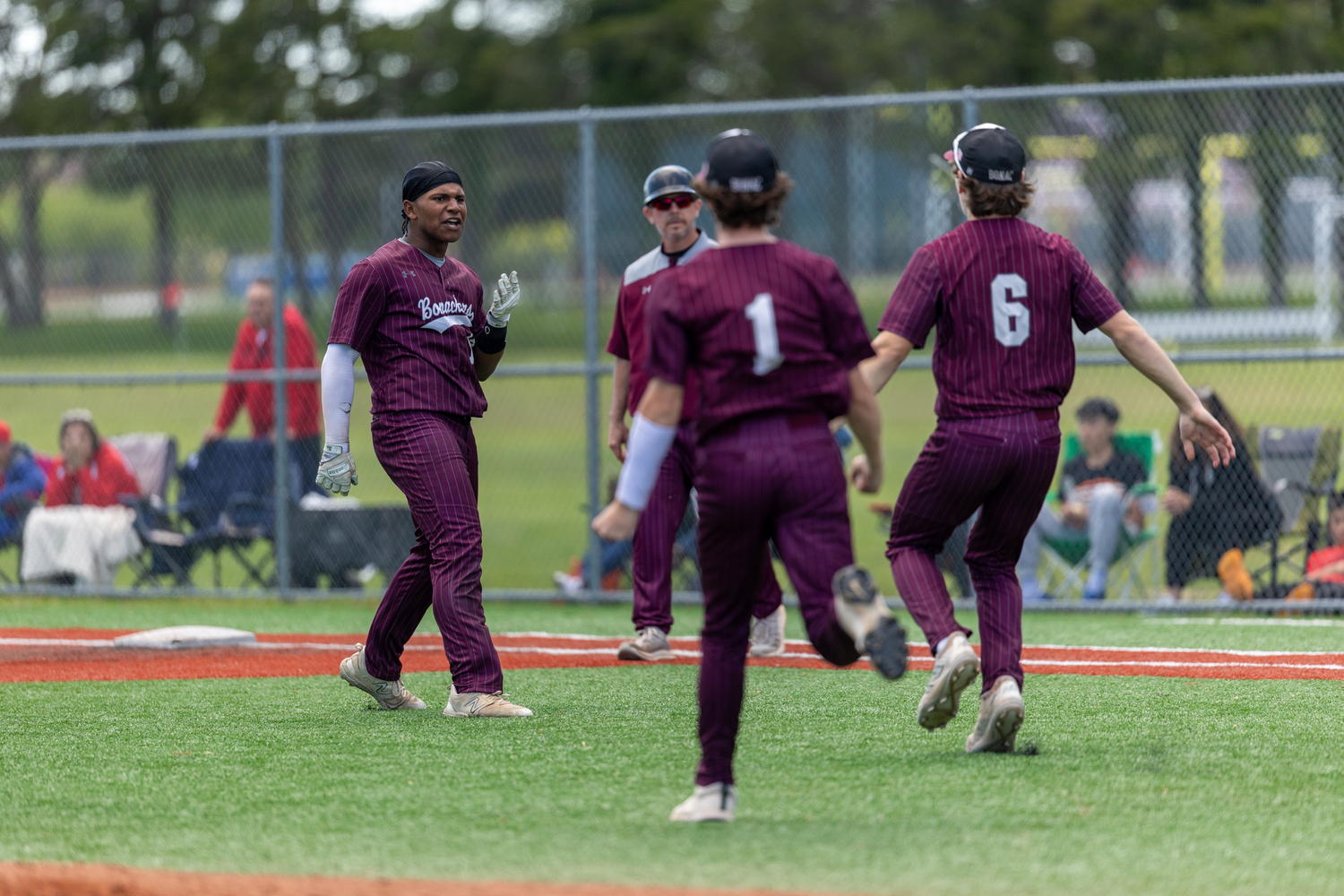 The Bonackers rush the field to celebrate their 2-1 walk-off victory with Victoreddy Aguero, whos base hit to left field drove in Hudson Meyer from second base for the game-winning run.   RON ESPOSITO