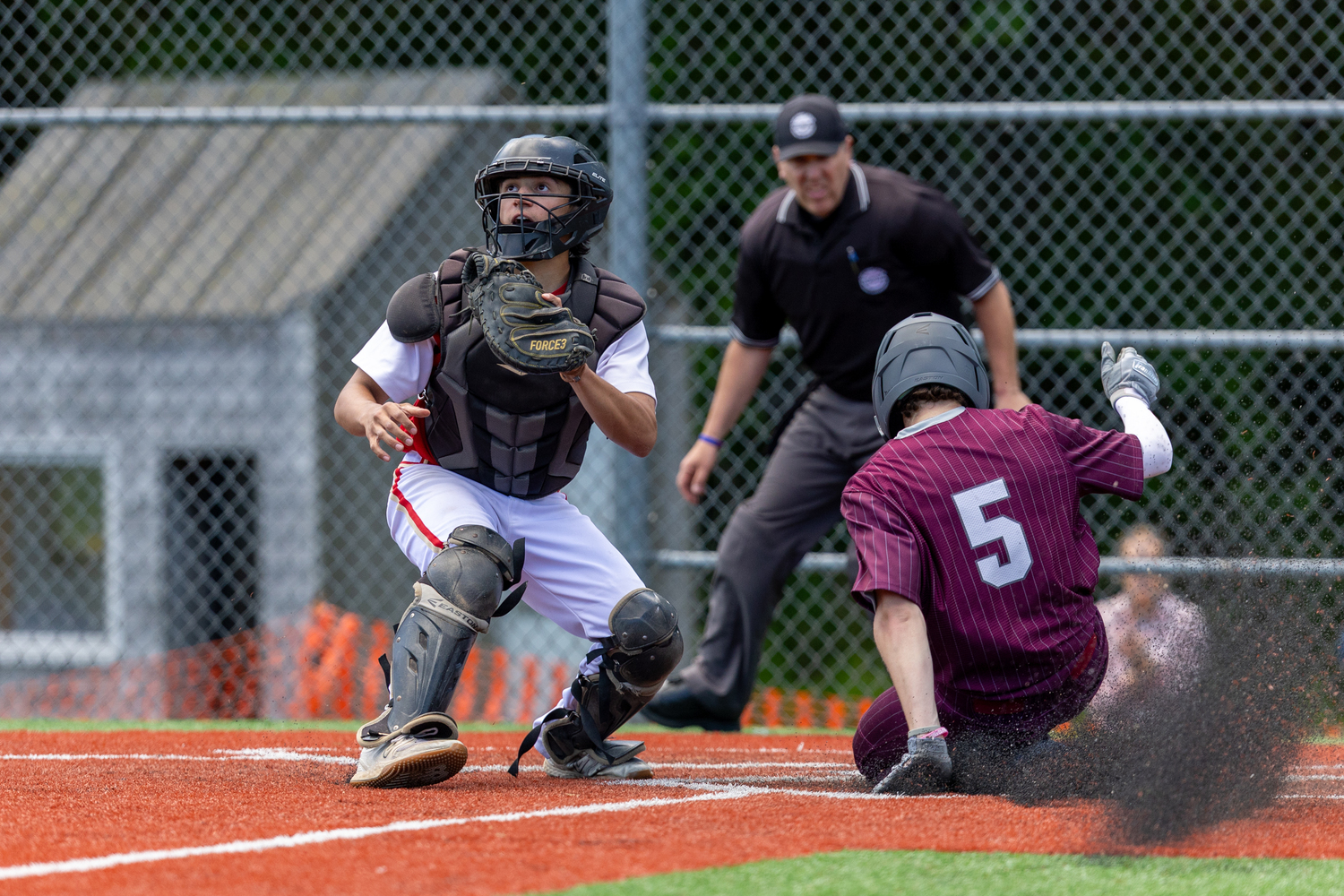 Hudson Meyer slides safely into home plate for the game-winning run on Monday.   RON ESPOSITO