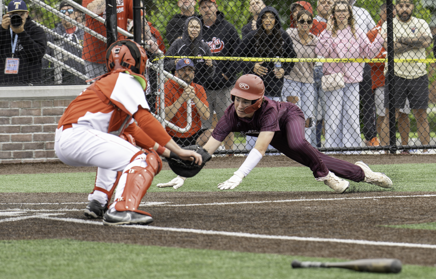 East Hampton senior Liam Cashin tries to score on Livs Kuplins base hit to center field but is thrown out at the plate.  MARIANNE BARNETT