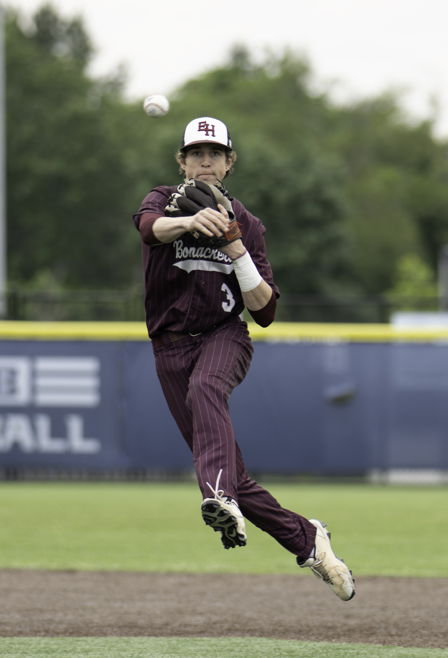 East Hampton second baseman Tyler Hansen throws to first for an out.   MARIANNE BARNETT