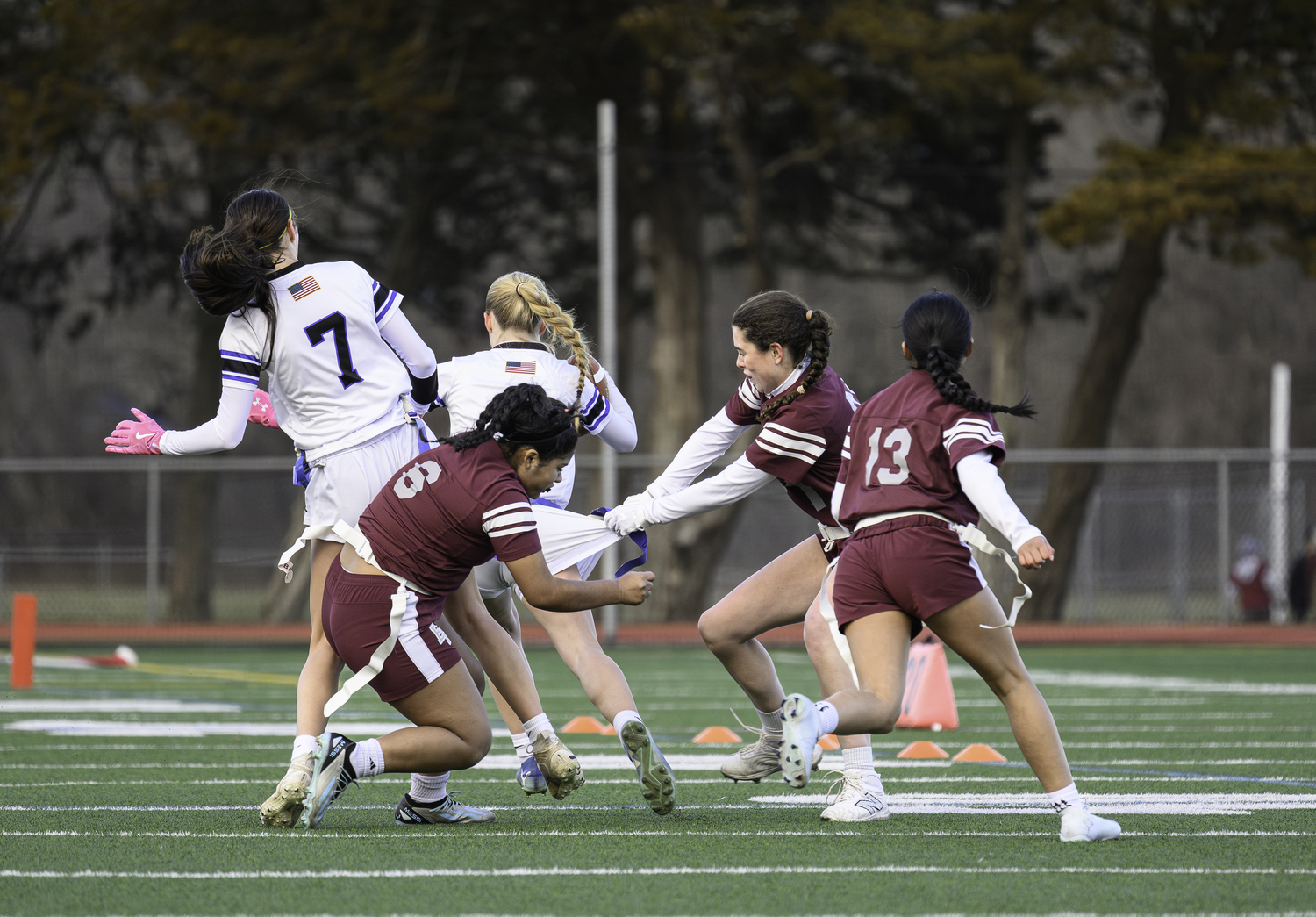Ella Menu goes in for a flag of an Elwood-John Glenn ball carrier in the season opener on March 26. MARIANNE BARNETT