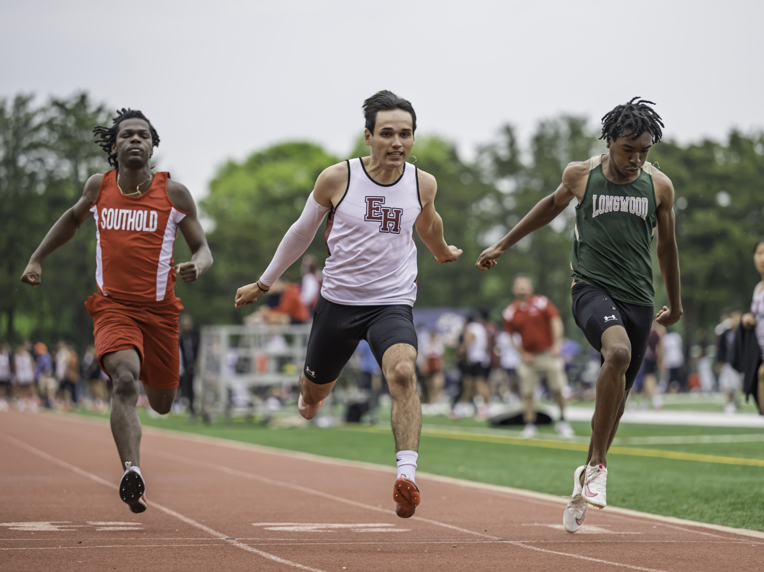 Thomas Cardenas crosses the finish line in the 100-meter dash.  MARIANNE BARNETT