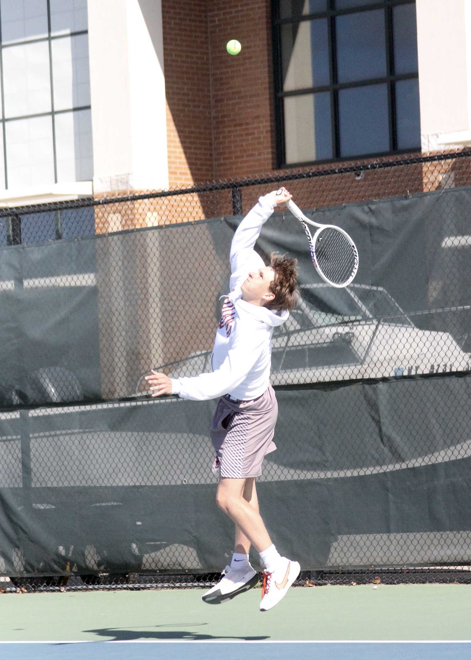 Senior C.J. Baumrind serves. DESIRÉE KEEGAN