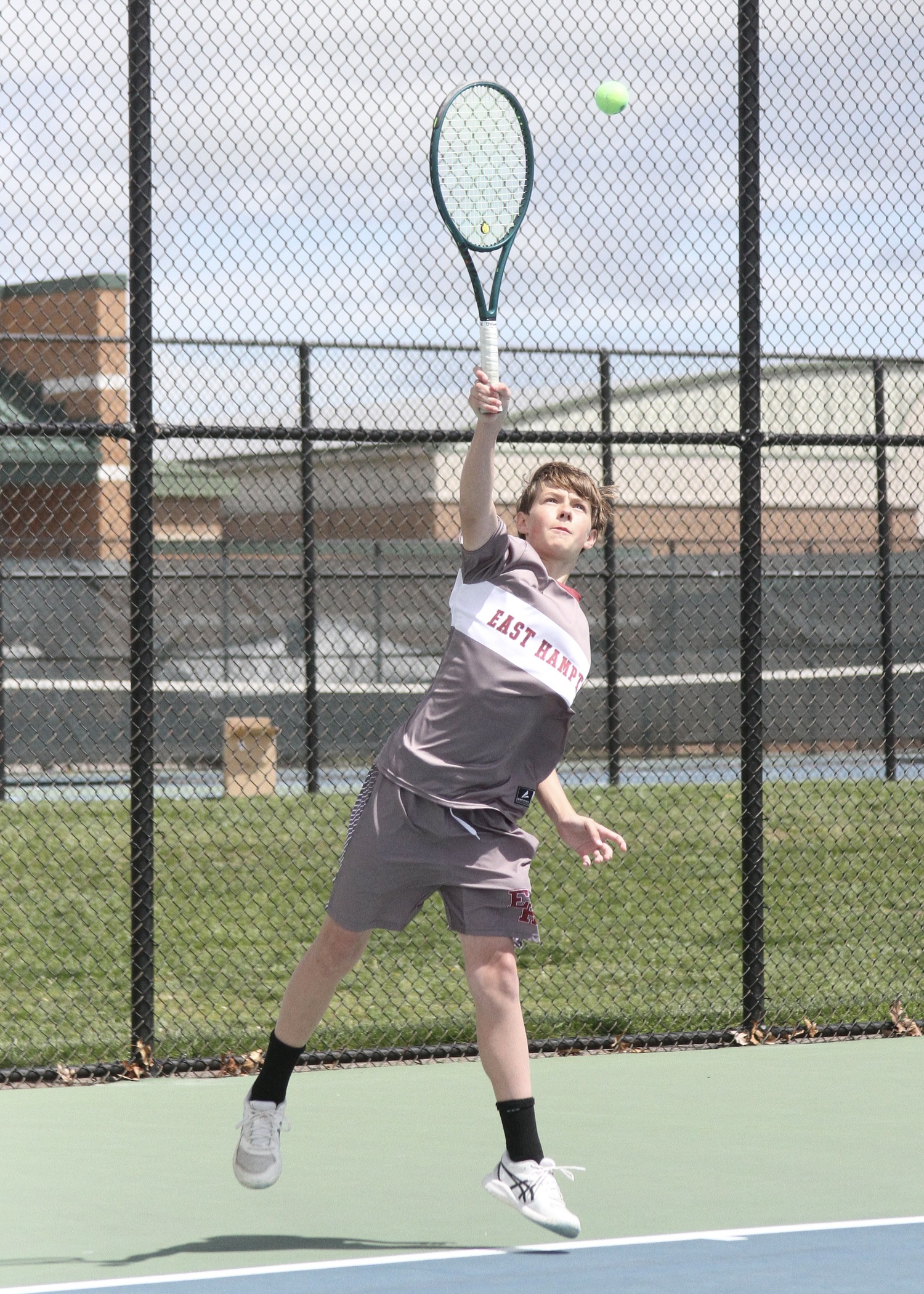 Eighth-grader Chase Bohnnsack serves. DESIRÉE KEEGAN