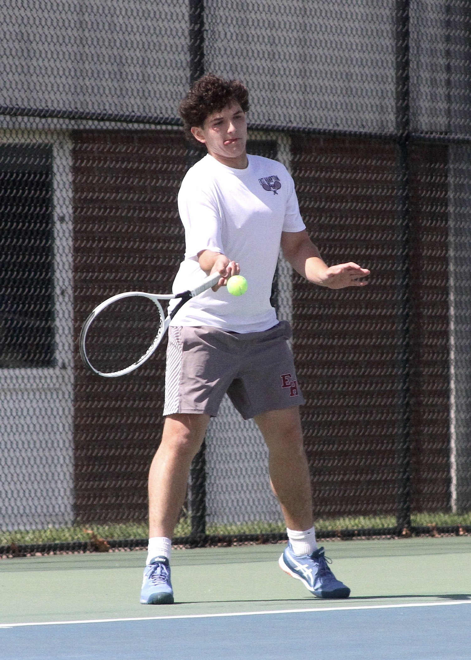 Junior Joseph Martinez returns a serve. DESIRÉE KEEGAN