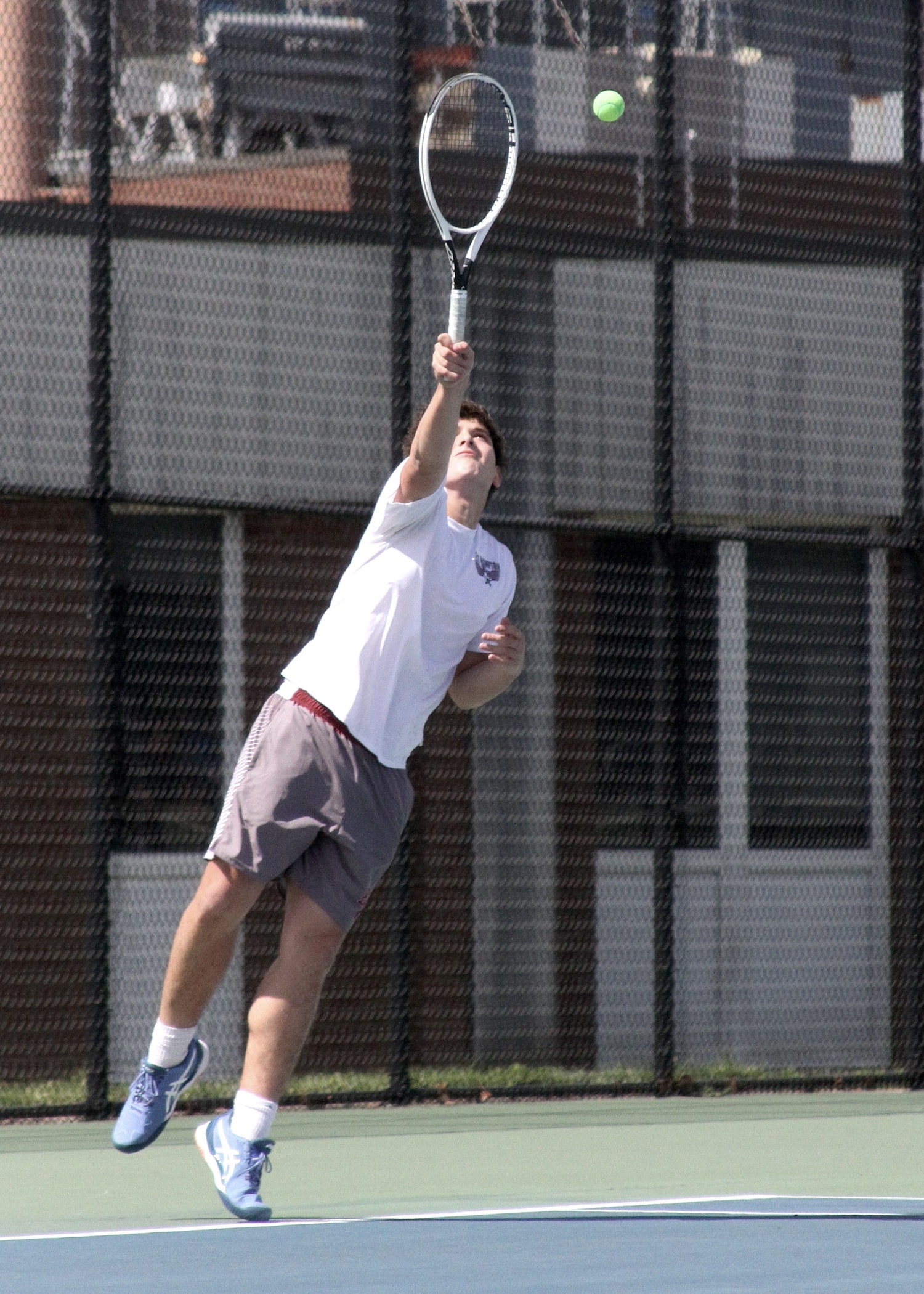 Junior Joseph Martinez serves. DESIRÉE KEEGAN