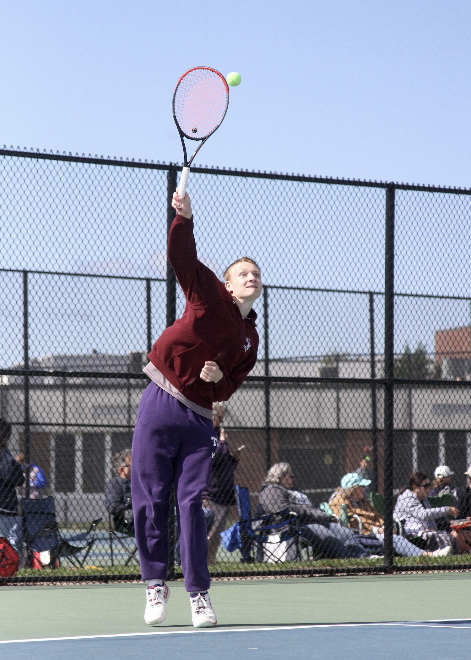 Senior Kiefer Mitchell serves. DESIRÉE KEEGAN