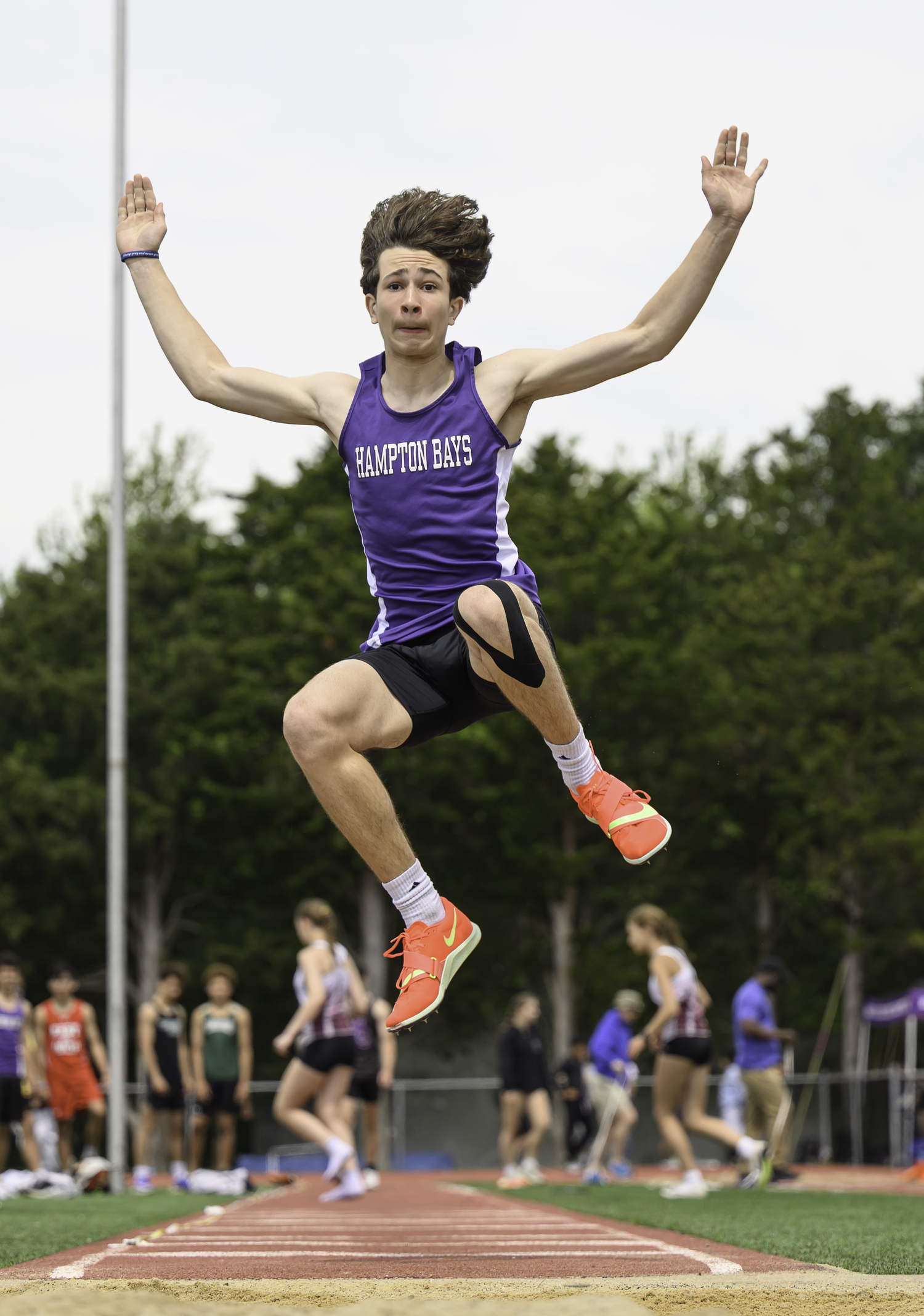 Hampton Bays freshman Daniel Pimenta leaps in the long jump.  MARIANNE BARNETT