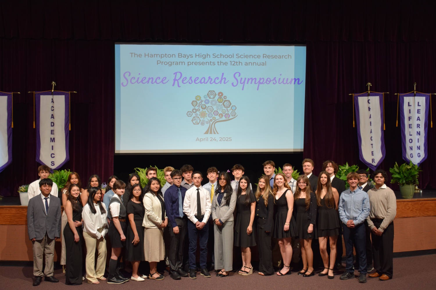 Hampton Bays High School recently hosted a successful 12th annual Science Research Symposium. During the event, research students presented their findings on a wide variety of topics, including anthropogenic effects on piping plovers, nautical anthropogenic effects on whale acoustics, surgical treatment for chronic migraines, and the impact of AI on the labor market. Following the student presentations, attendees asked questions. Also speaking
during the event was guest speaker Christopher Paparo of the School of Marine and Atmospheric Sciences at Stony Brook University, also known as the 