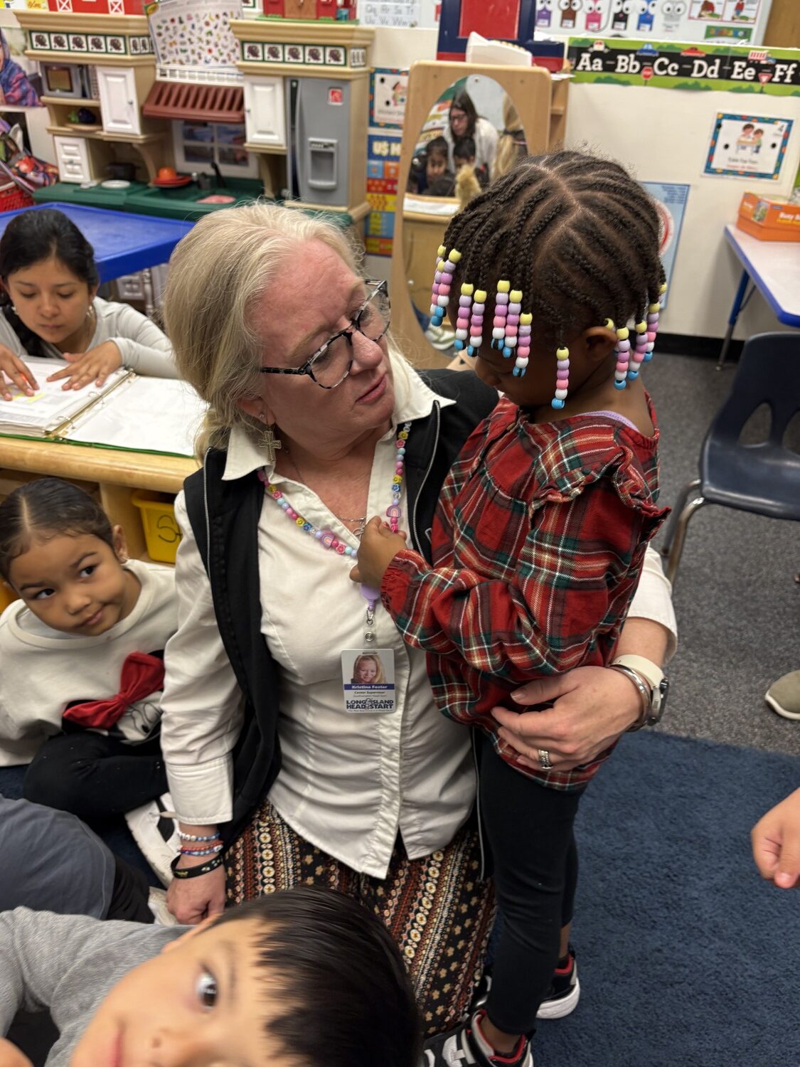 Kristina Foster spends a moment with a student. CAILIN RILEY