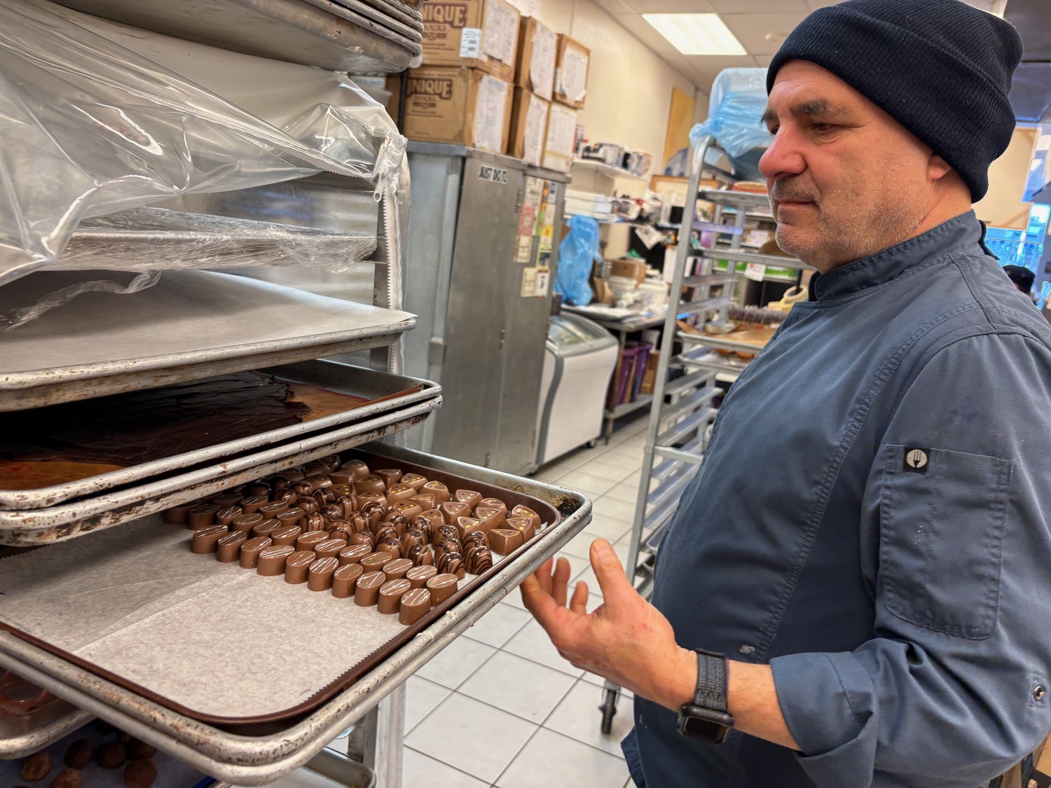 Amaral shows off a tray of freshly made chocolates in the Riverhead kitchen.