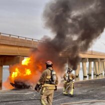 Hampton Bays Fire Department firefighters put out a car blaze near Ponquogue Bridge on Sunday morning. COURTESY HBFD