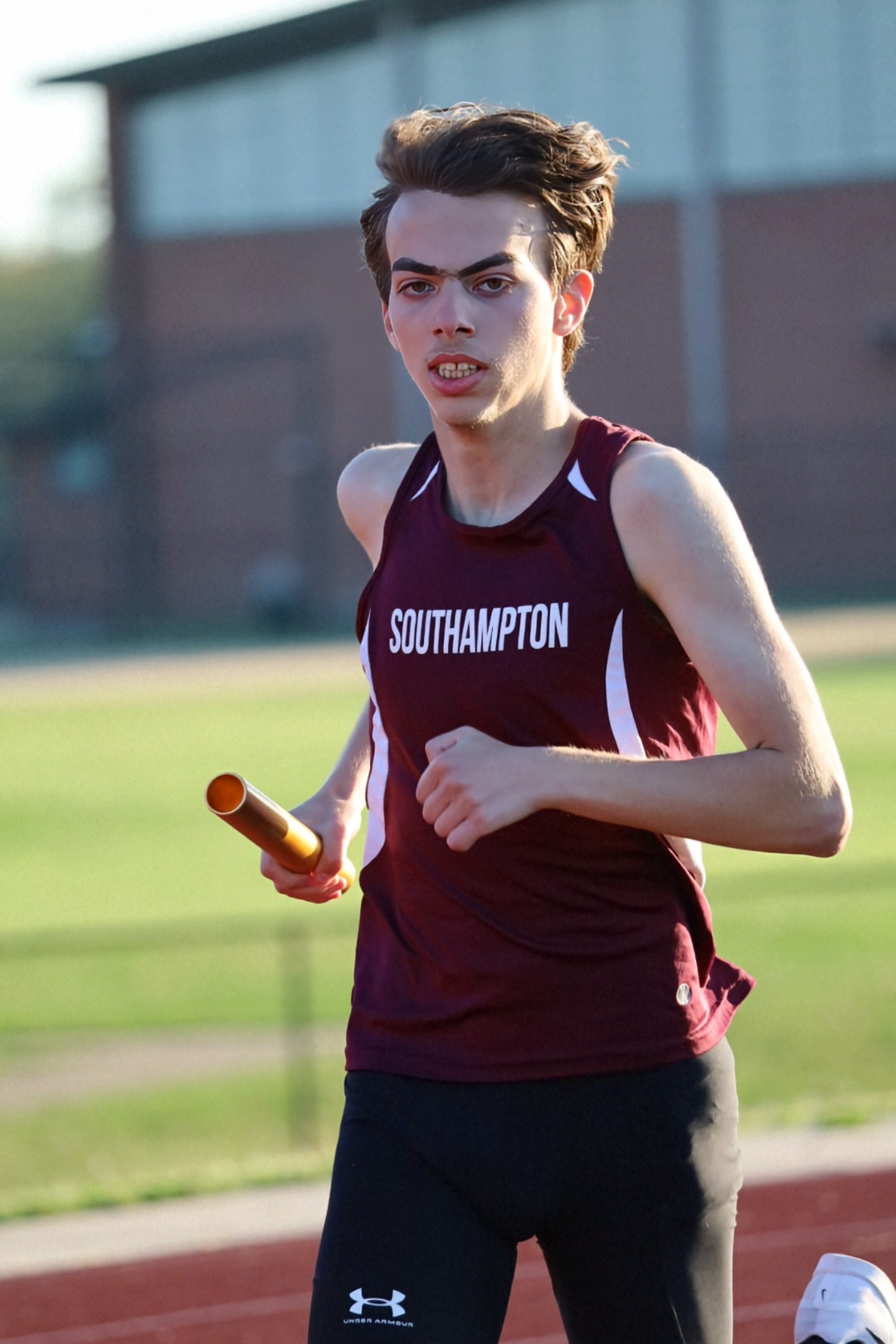 Jake Cook running in a relay.  JAMIE CARLSEN