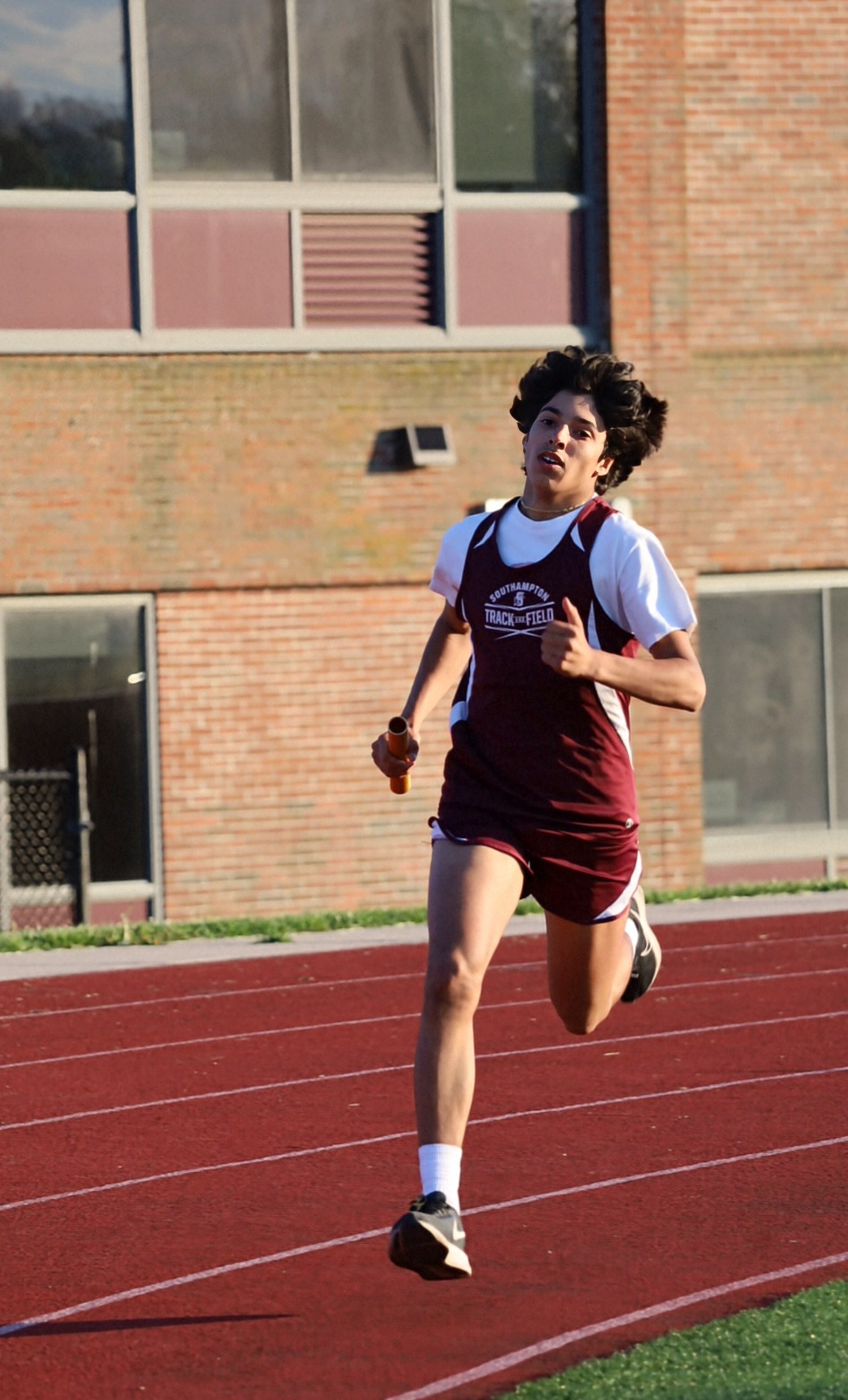 Tristan Angel runs in a relay.  JAMIE CARLSEN