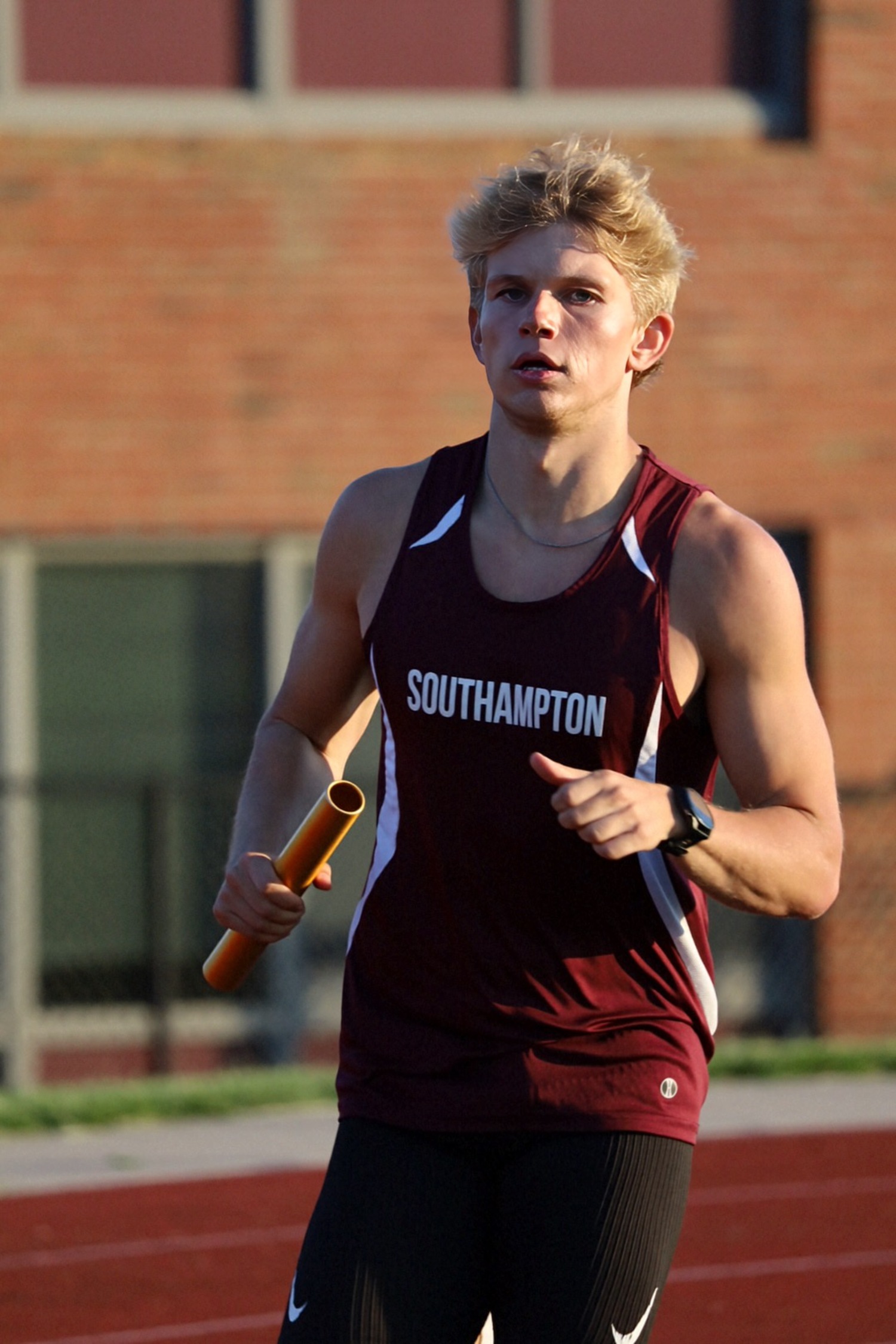 Christian Duggal runs in a relay.  JAMIE CARLSEN
