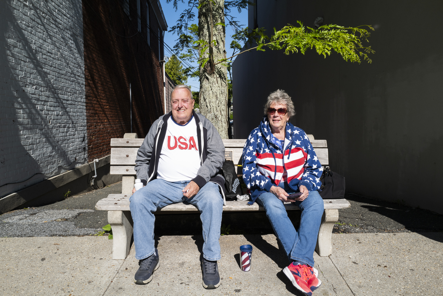 Ron and Patty Foster of Sag Harbor enjoy the Sag Harbor Memorial Day parade from their bench on Main Street. LORI HAWKINS PHOTOS