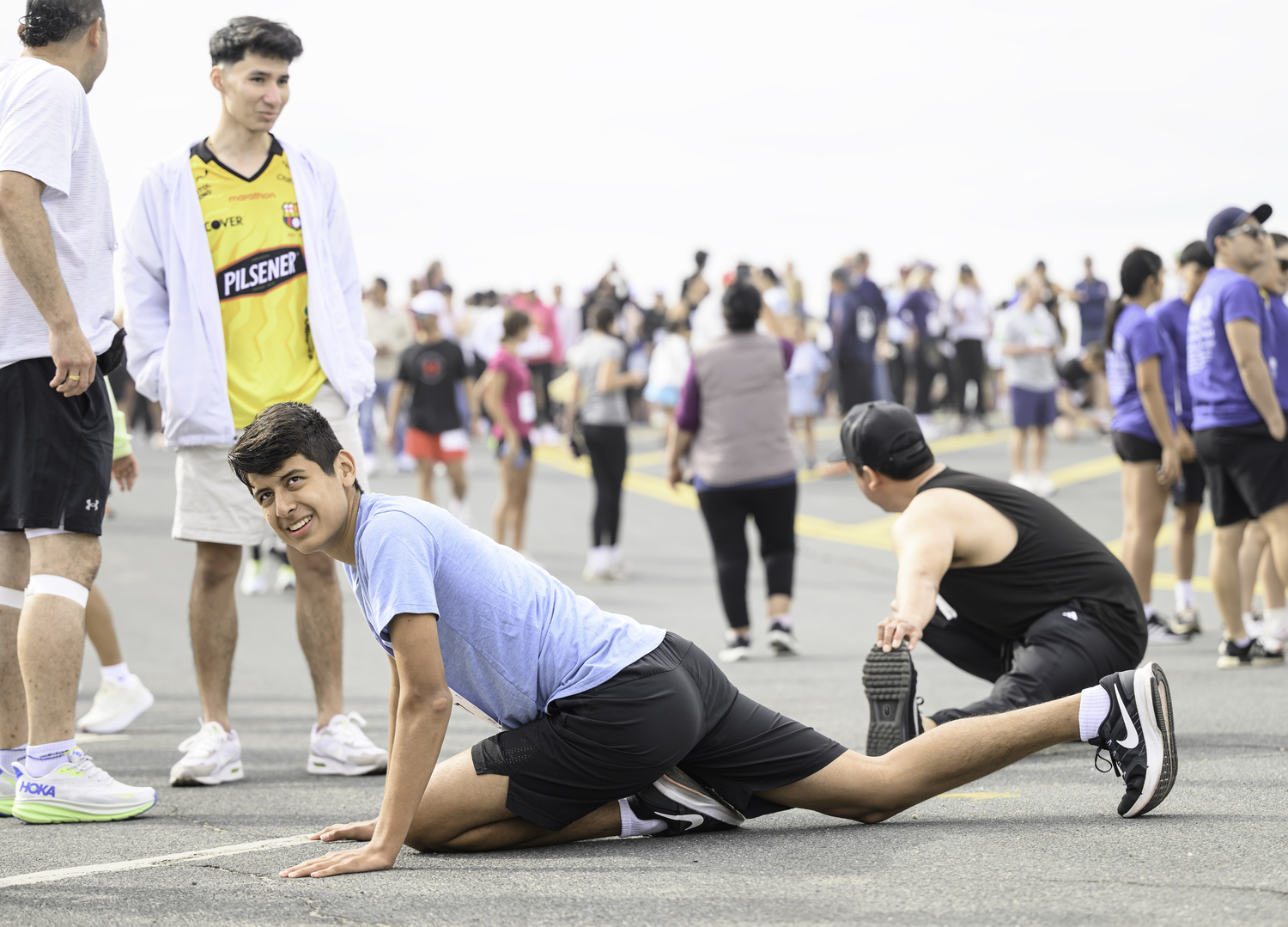 Runners stretch and warm up just prior to Sunday's race.   MARIANNE BARNETT
