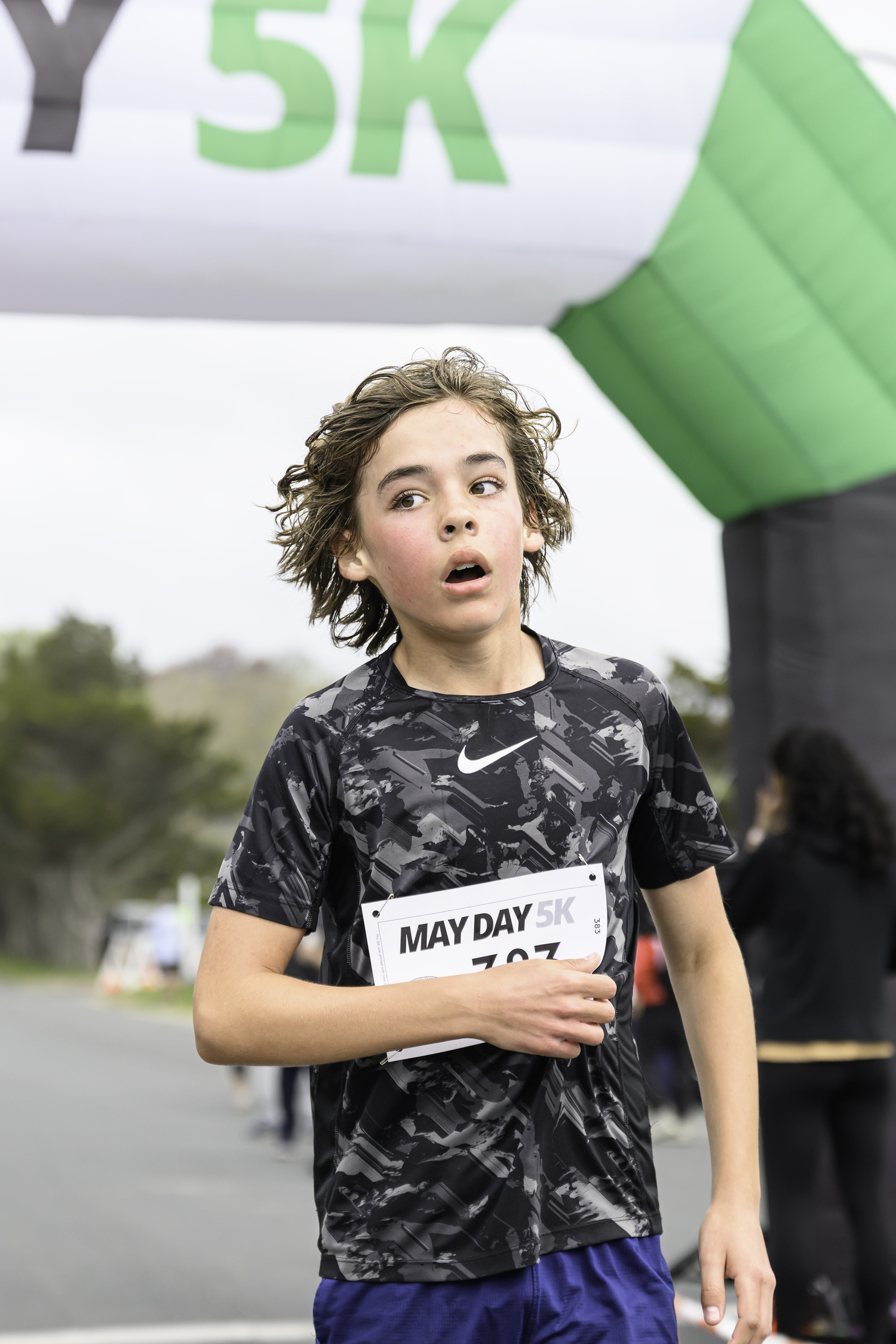 A young runner crosses the finish line.  MARIANNE BARNETT