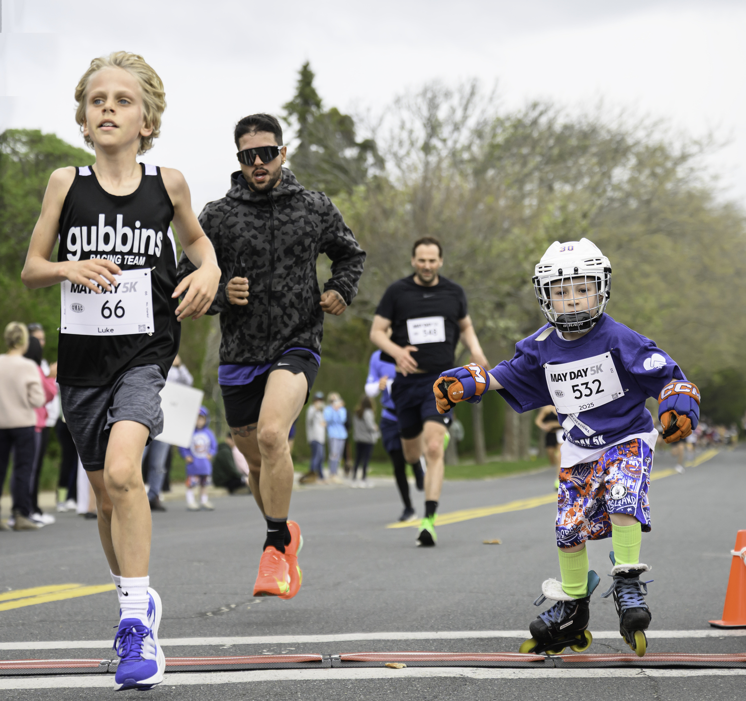 Young participants cross the finish line.   MARIANNE BARNETT