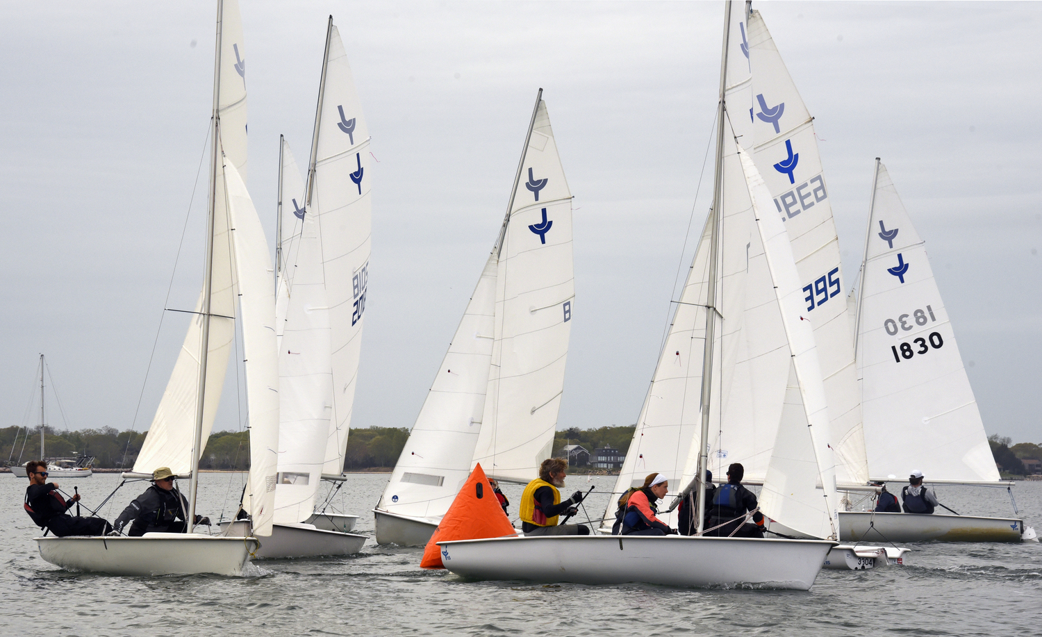 Rounding the weather mark is not for the fainthearted! Another stalwart club team, Derrick Galen and Amelia Steelman, sails now eased, are in the foreground heading for the gybe mark. MICHAEL MELLA