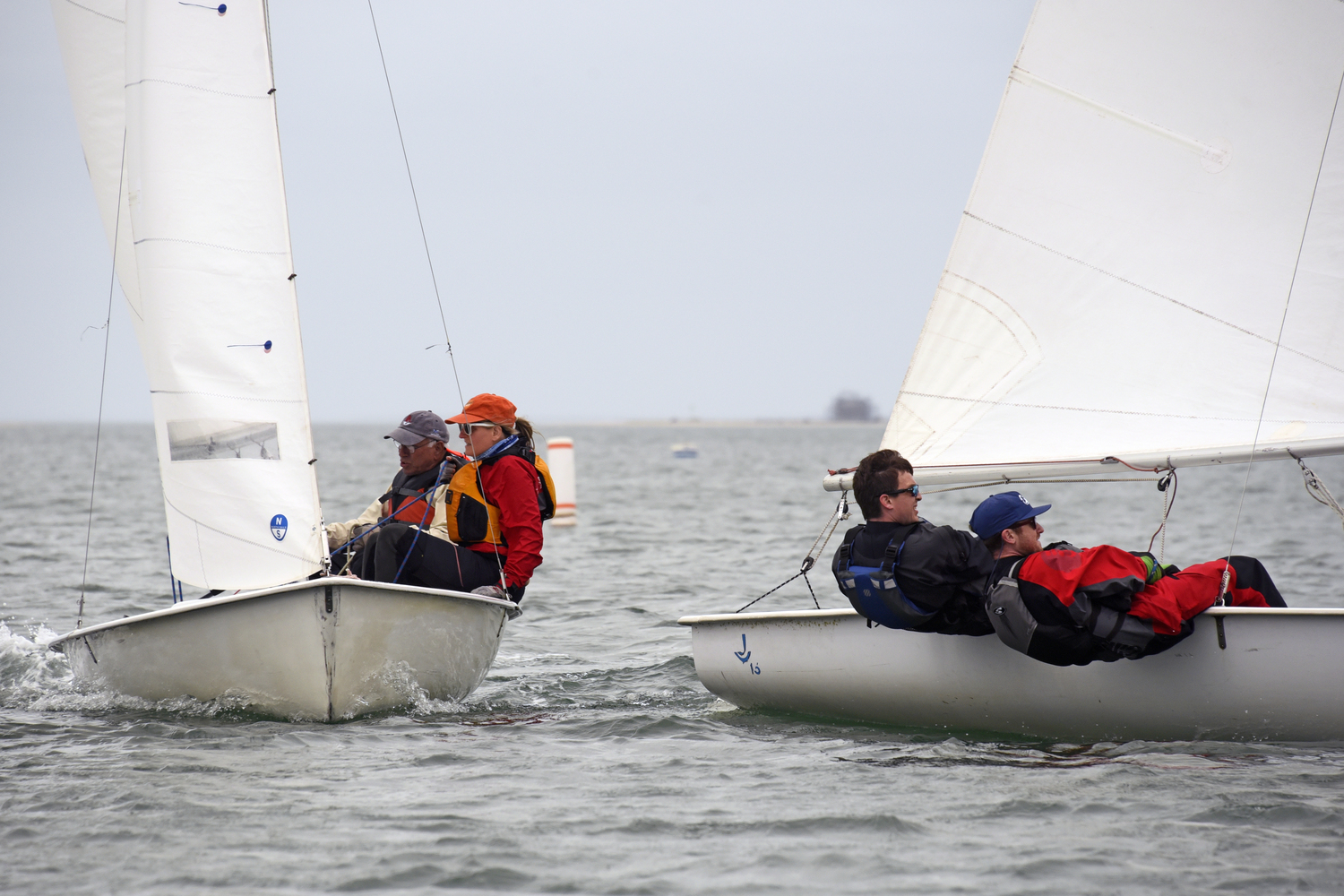 Lee Oldak, left, owner/skipper of the hard-to-beat sloop Purple Haze on every Wednesday night race, on port tack, giving room to privileged starboard tack skipper Dylan Abel. MICHAEL MELLA