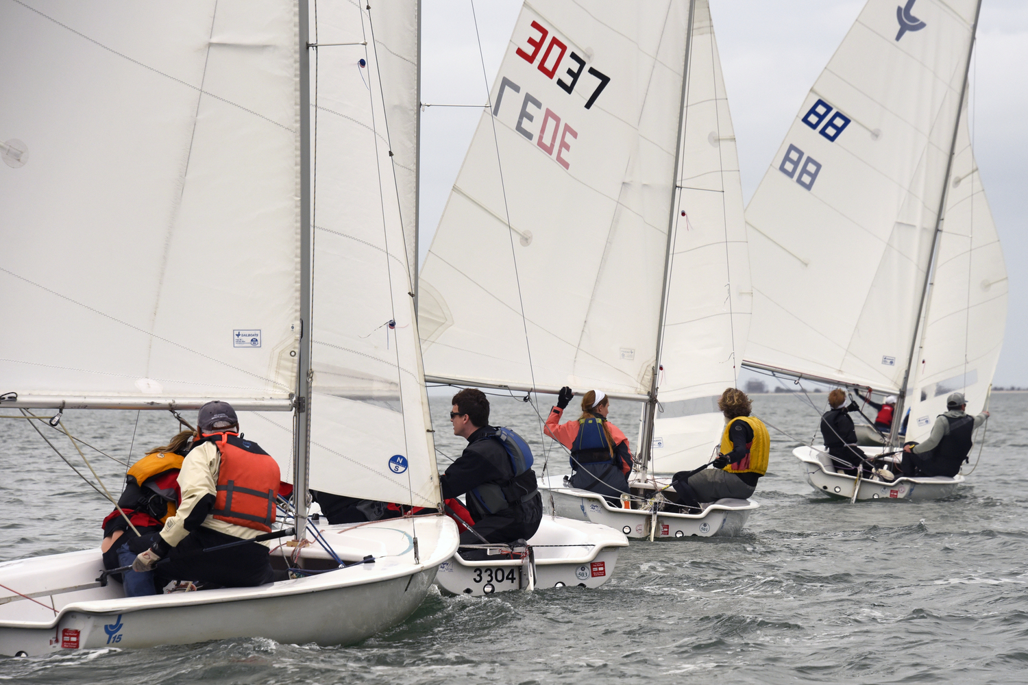 Broad reaching, some boats “wing and wing.” The tiny red PFD clad/white hat person below the boom of #88 is none other than Sinéad FitzGibbon; she and David Whelen on their way to another win. MICHAEL MELLA