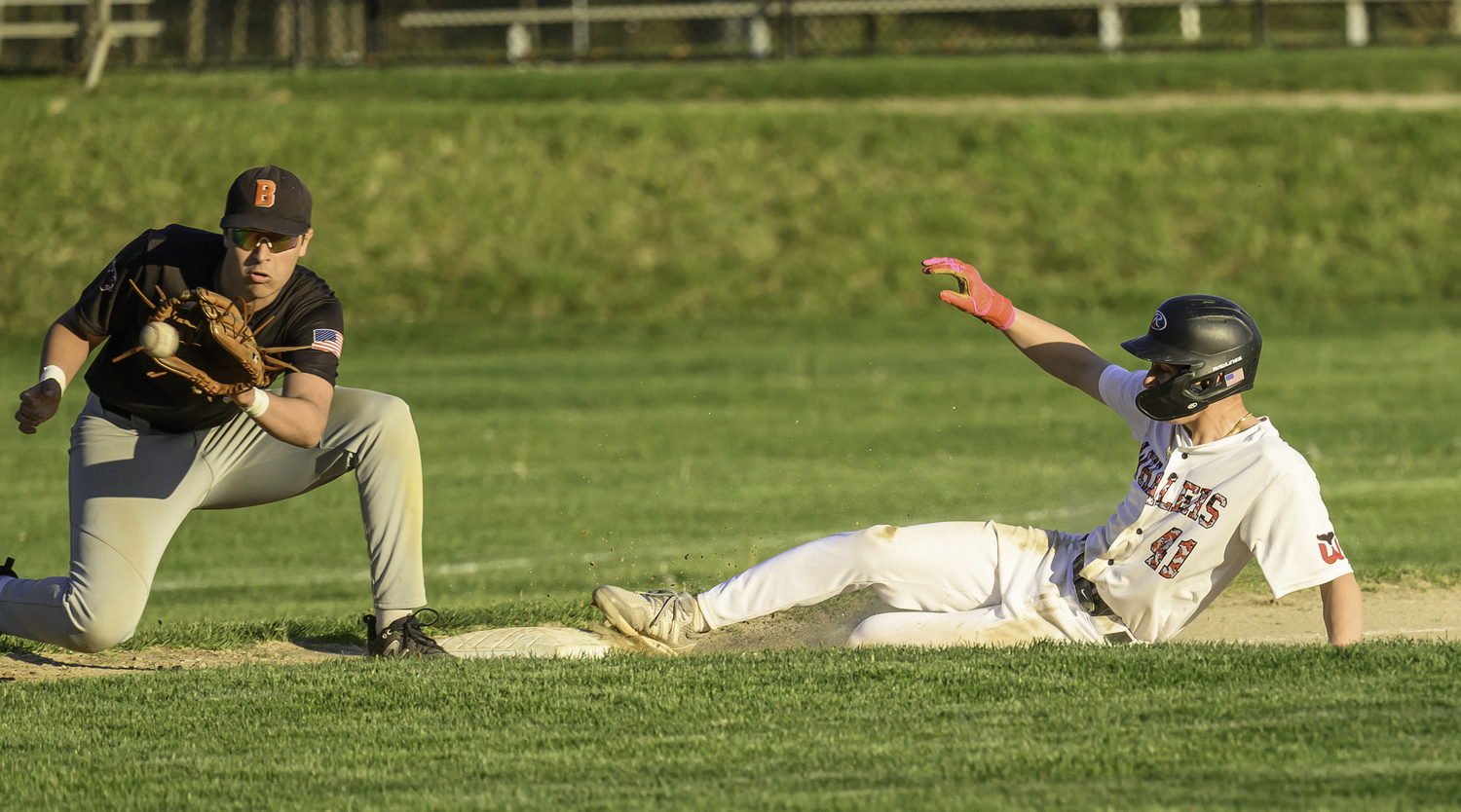 Andy Wayne slides safely into third base.  MARIANNE BARNETT