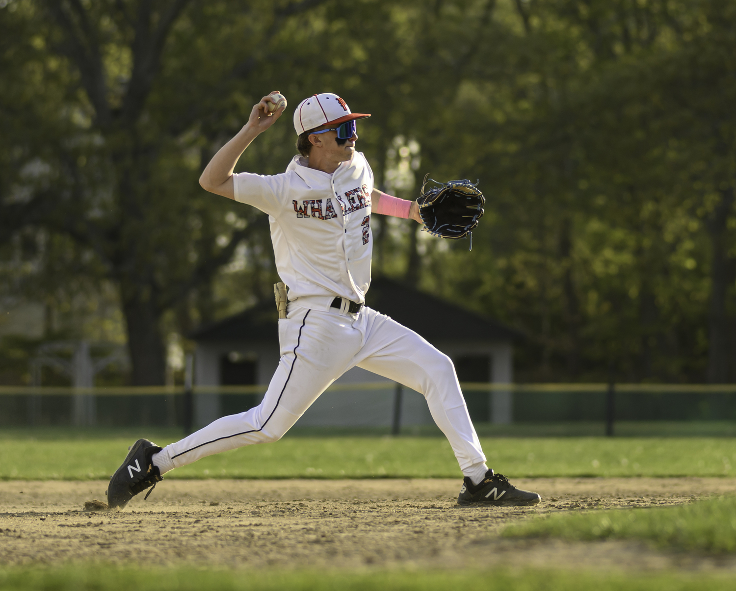 Whaler Brian Schroeder throws to first base for an out.   MARIANNE BARNETT