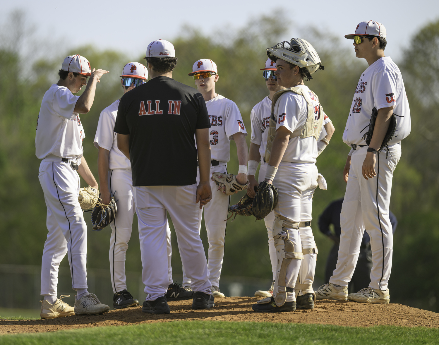 Pierson assistant coach Tyler Laborne meets up with the infield during the first inning.   MARIANNE BARNETT