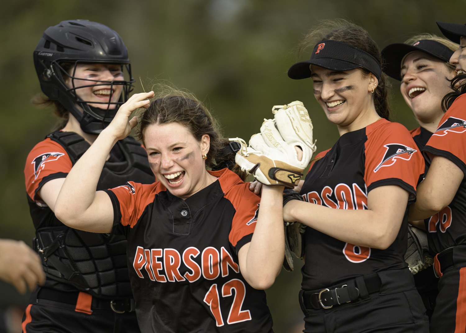 Fiona Martin is congratulated by her teammates for tossing a clean inning.   MARIANNE BARNETT