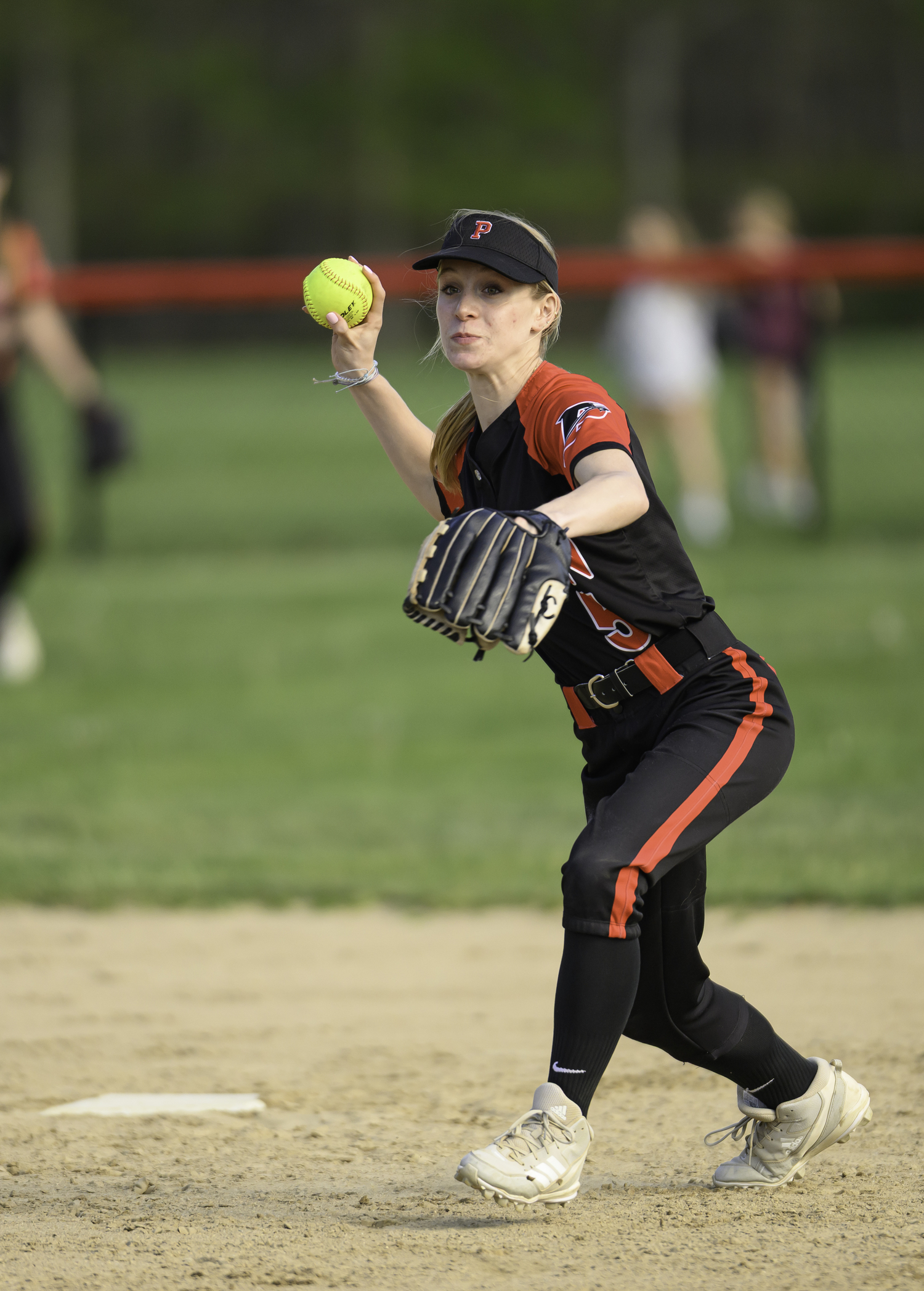 Kira Martin throws to first for an out.  MARIANNE BARNETT