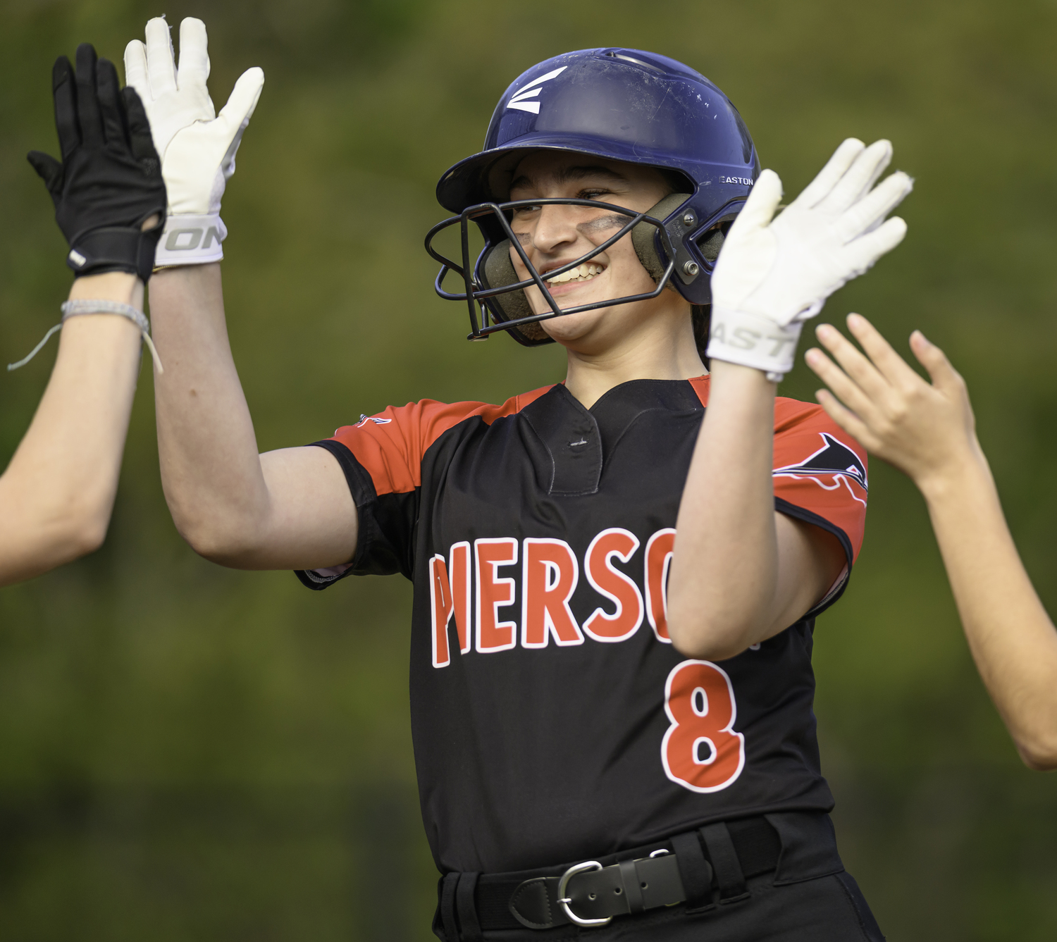 Sofia Zappola is congratulated after scoring a run.   MARIANNE BARNETT