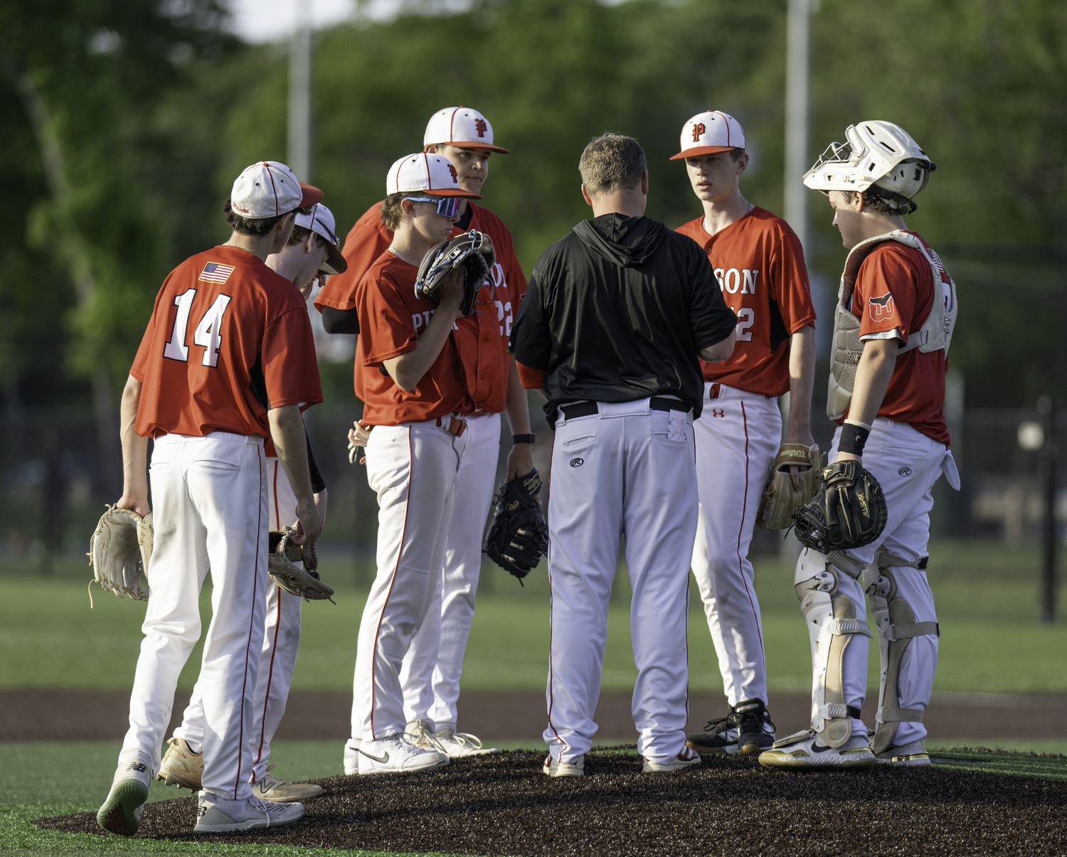 Pierson players gather on the mound to talk strategy. MARIANNE BARNETT