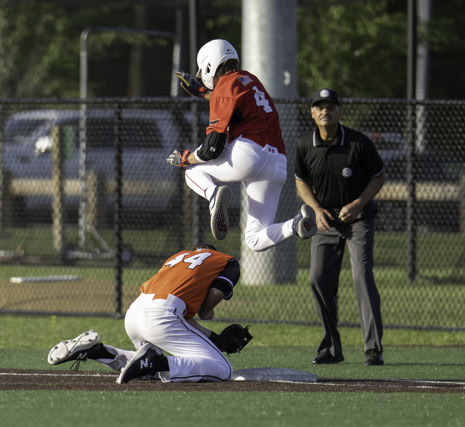 Pierson's Thomas Perri leaps to avoid Babylon's first baseman.  MARIANNE BARNETT