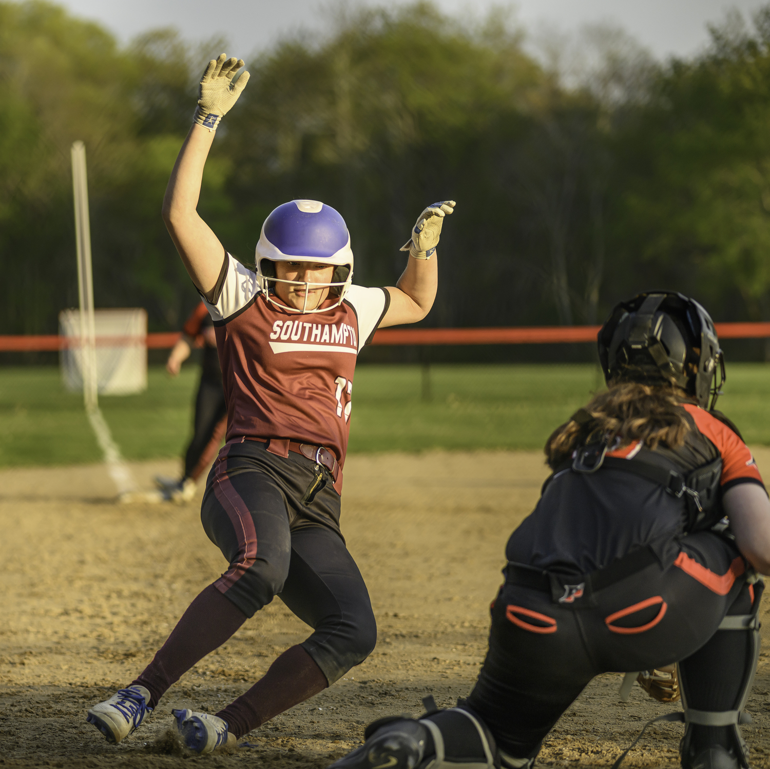 Maggie Glanz scores the first of what wound up being five runs in the last inning for the Mariners to come back and win. MARIANNE BARNETT