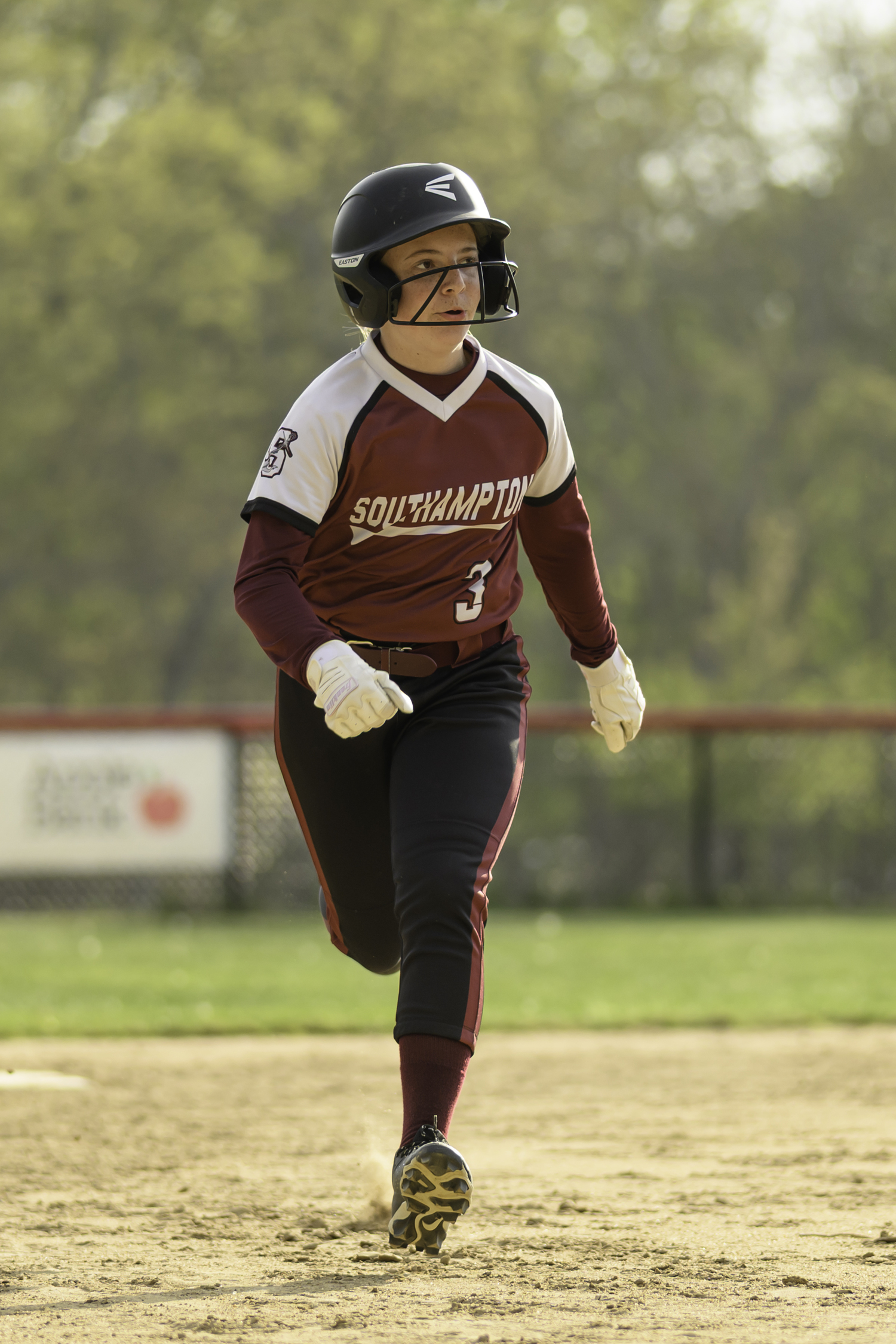 Taylor Olsen runs to third base.  MARIANNE BARNETT