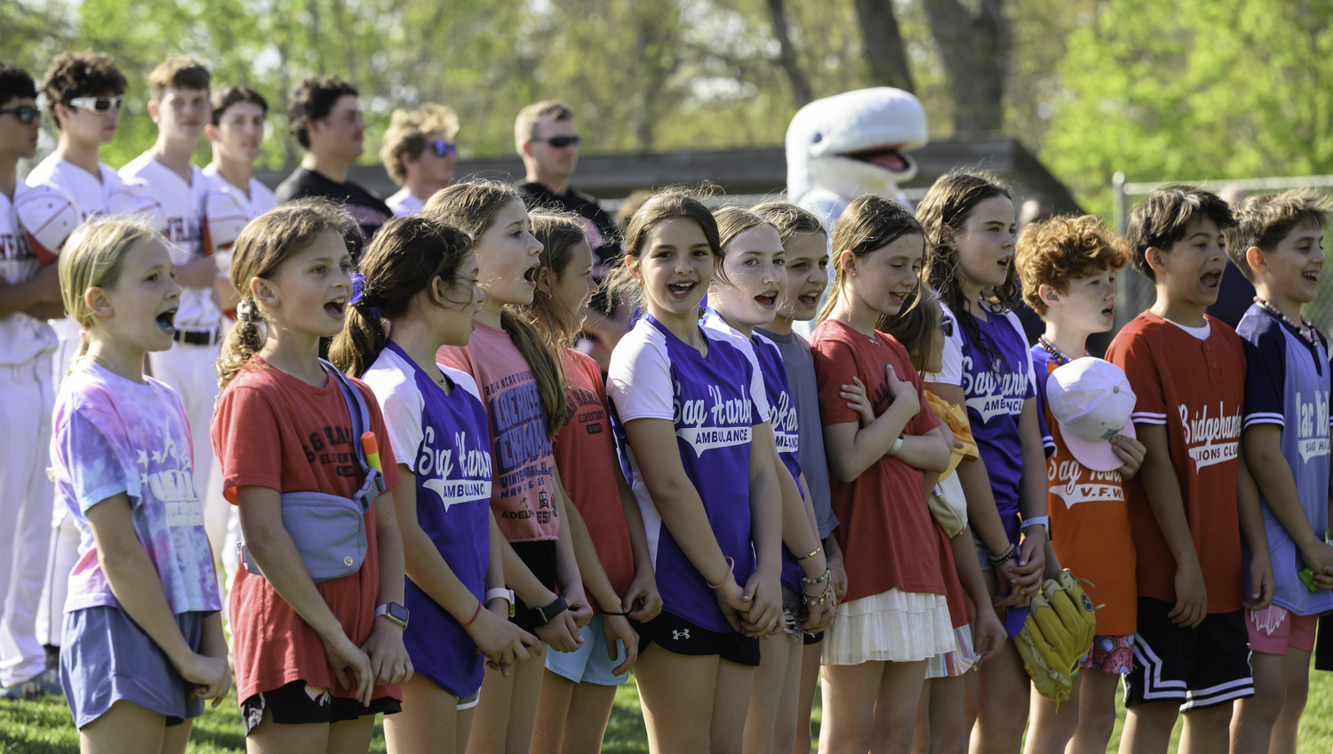 Young ballplayers of the Sag Harbor Little League since the national anthem prior to the Pierson varsity baseball game on Friday.  MARIANNE BARNETT