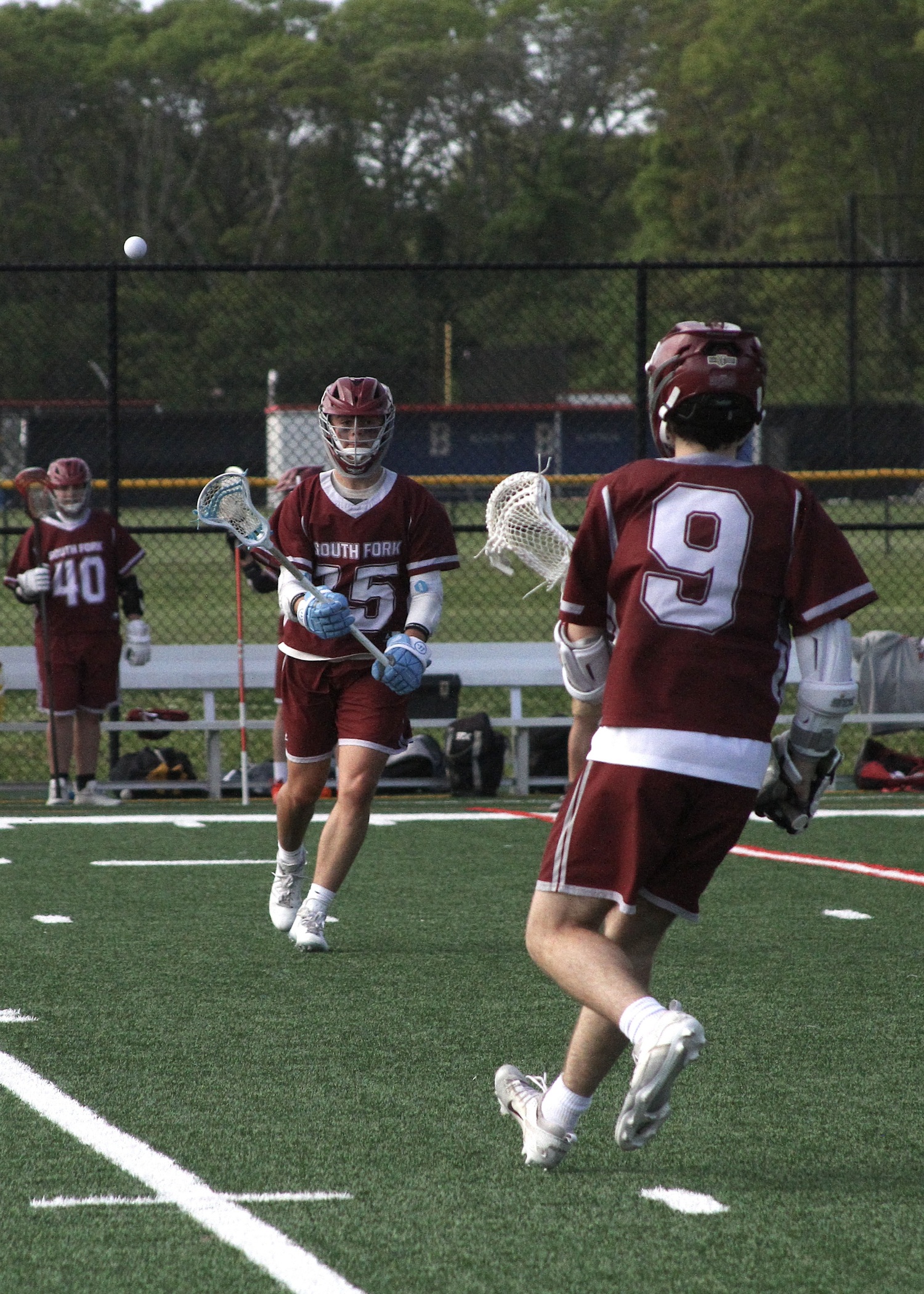 Hampton Bays sophomore Brayden Talmage passes the ball to Pierson senior Slate Glick. DESIRÉE KEEGAN