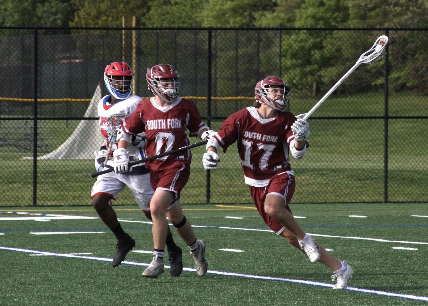 East Hampton sophomore Zane Karoussos grabs a loose ball mid-air. DESIRÉE KEEGAN