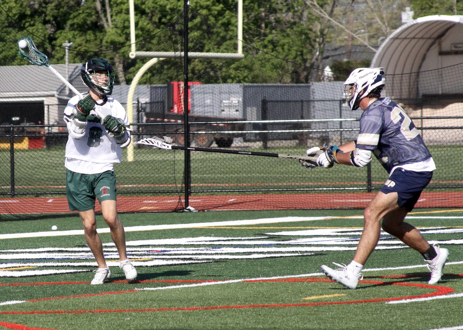 Senior Drew Calloway passes the ball from behind the cage. DESIRÉE KEEGAN