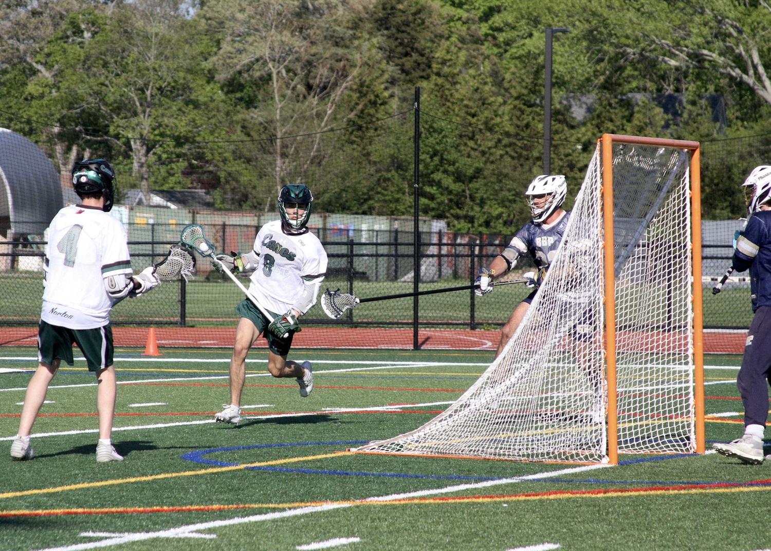 Senior Drew Calloway races around the back of the cage. DESIRÉE KEEGAN