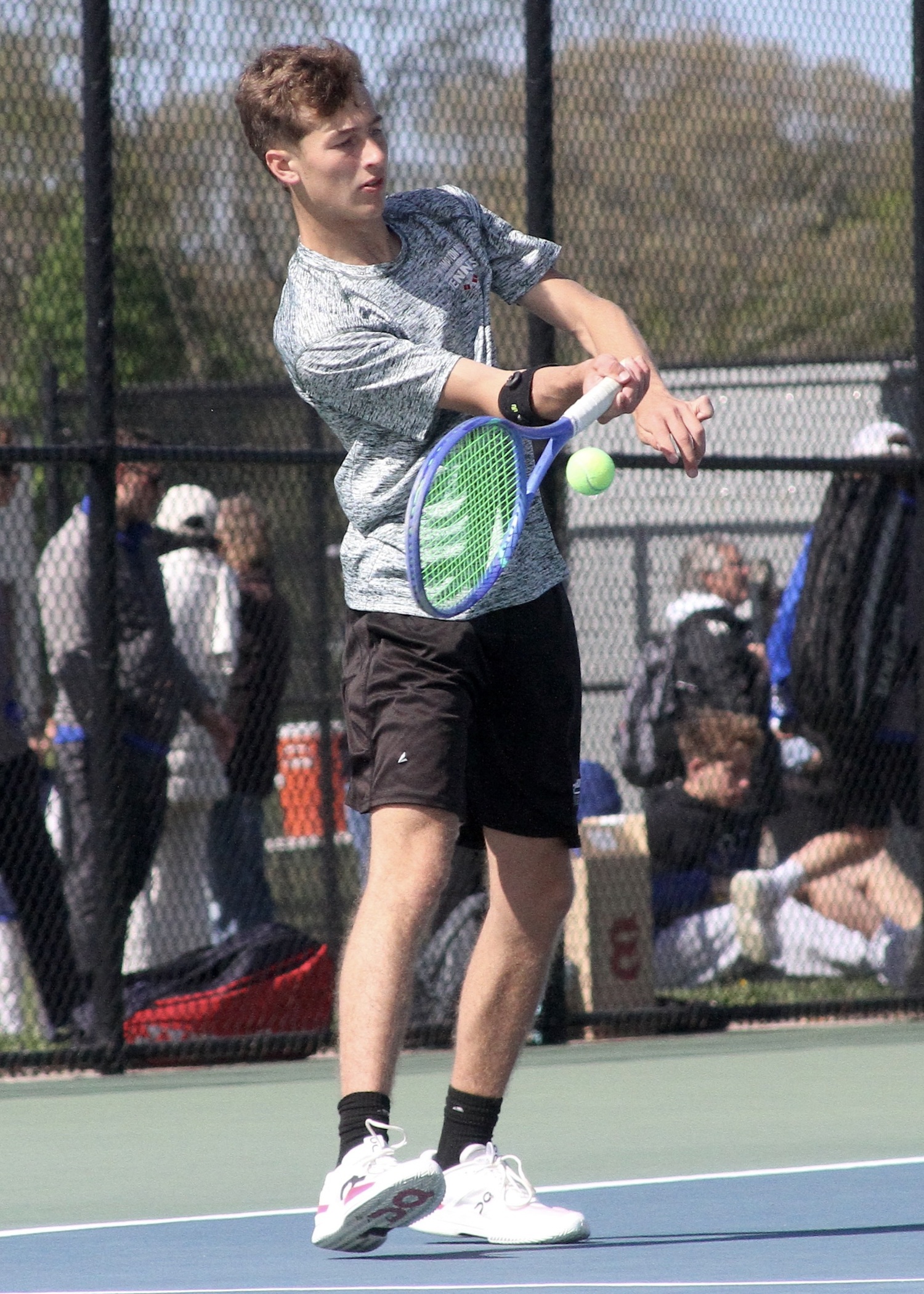 Junior Bryce Groth returns the ball. DESIRÉE KEEGAN