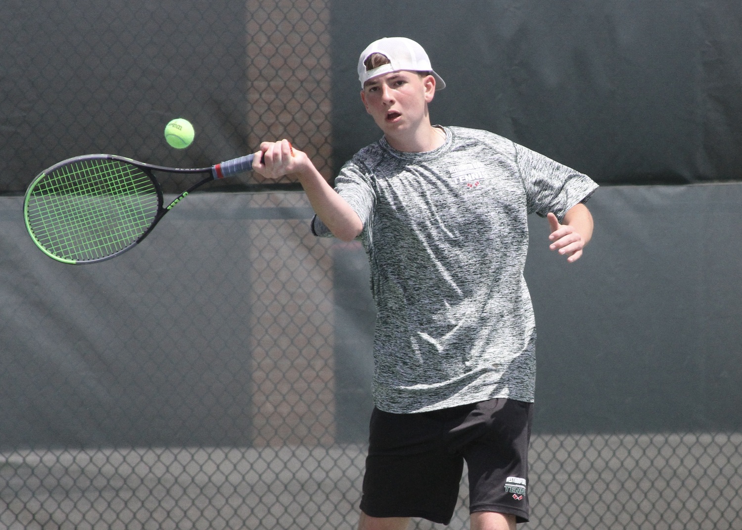 Sophomore David Meyers returns the ball. DESIRÉE KEEGAN