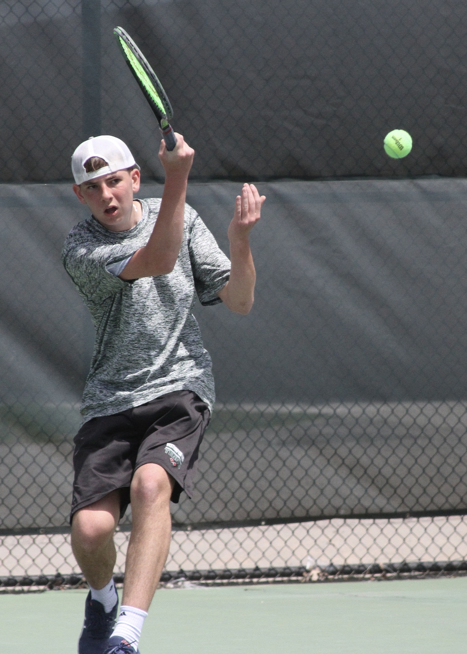 Sophomore David Meyers powers the ball back over the net. DESIRÉE KEEGAN