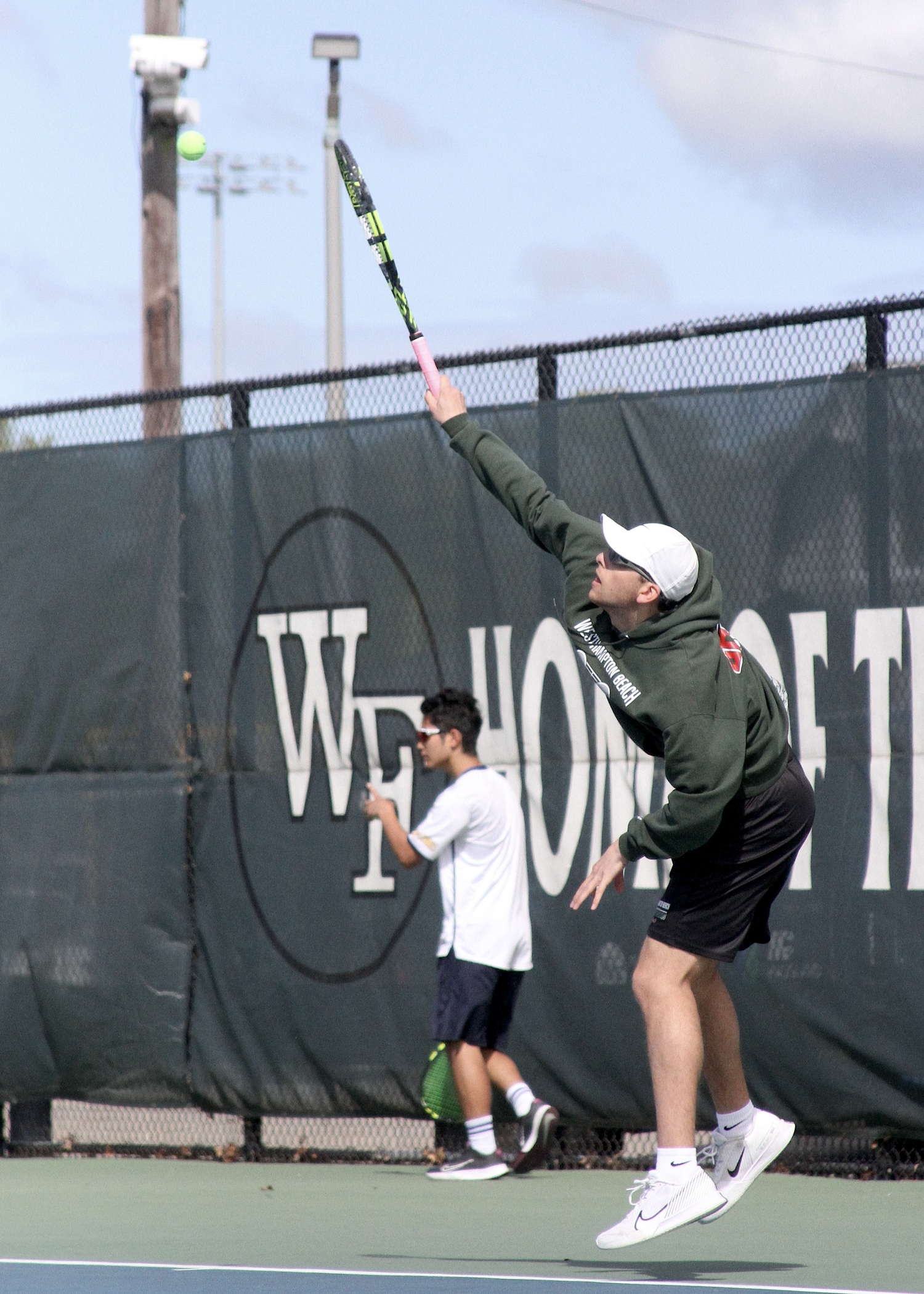 Senior Giancarlo Volpe serves. DESIRÉE KEEGAN