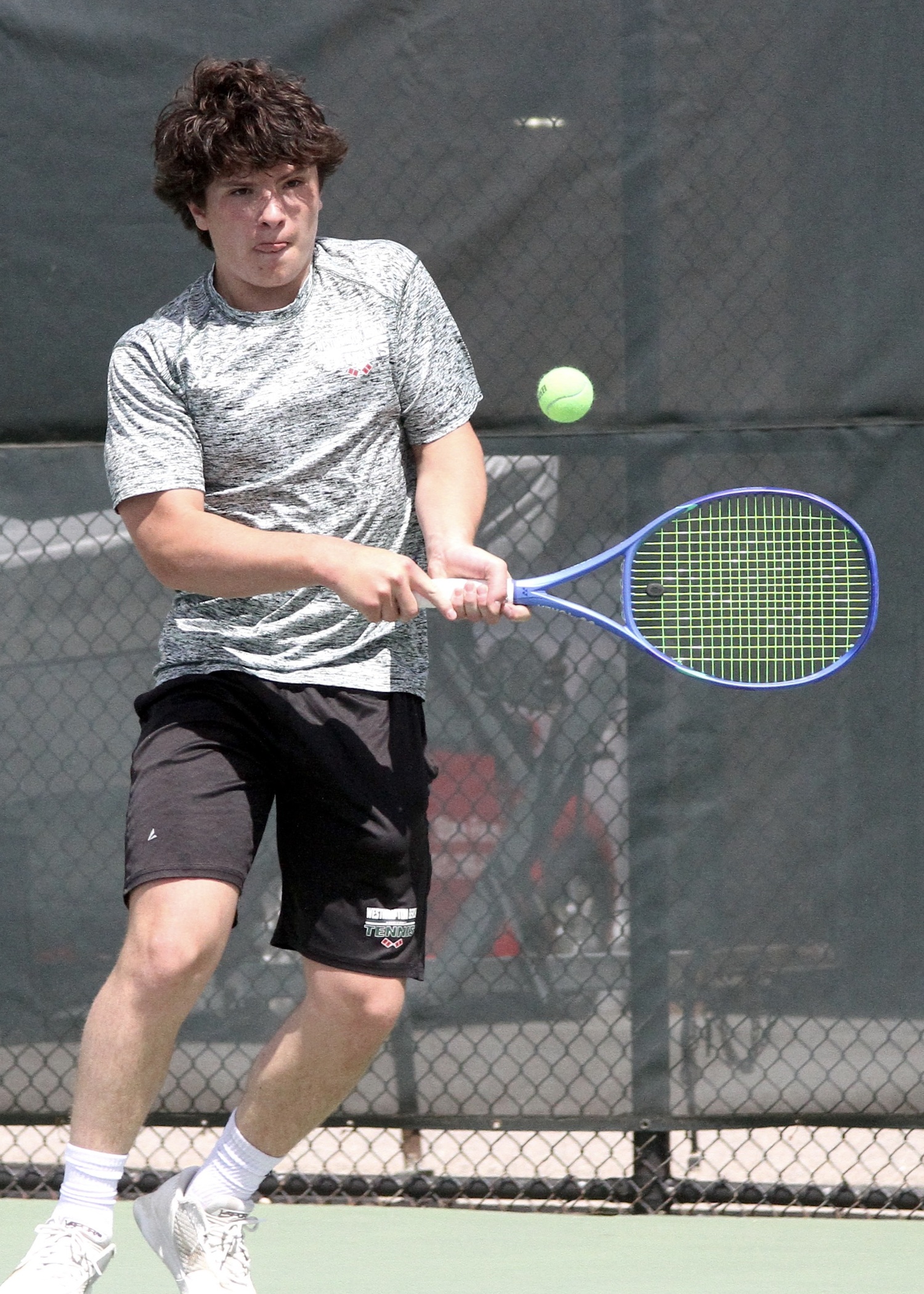 Freshman Ian Besser returns a serve. DESIRÉE KEEGAN