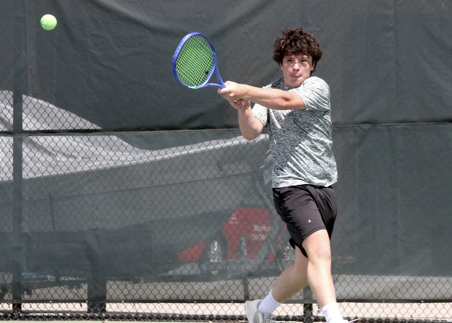 Freshman Ian Besser powers the ball back over the net. DESIRÉE KEEGAN