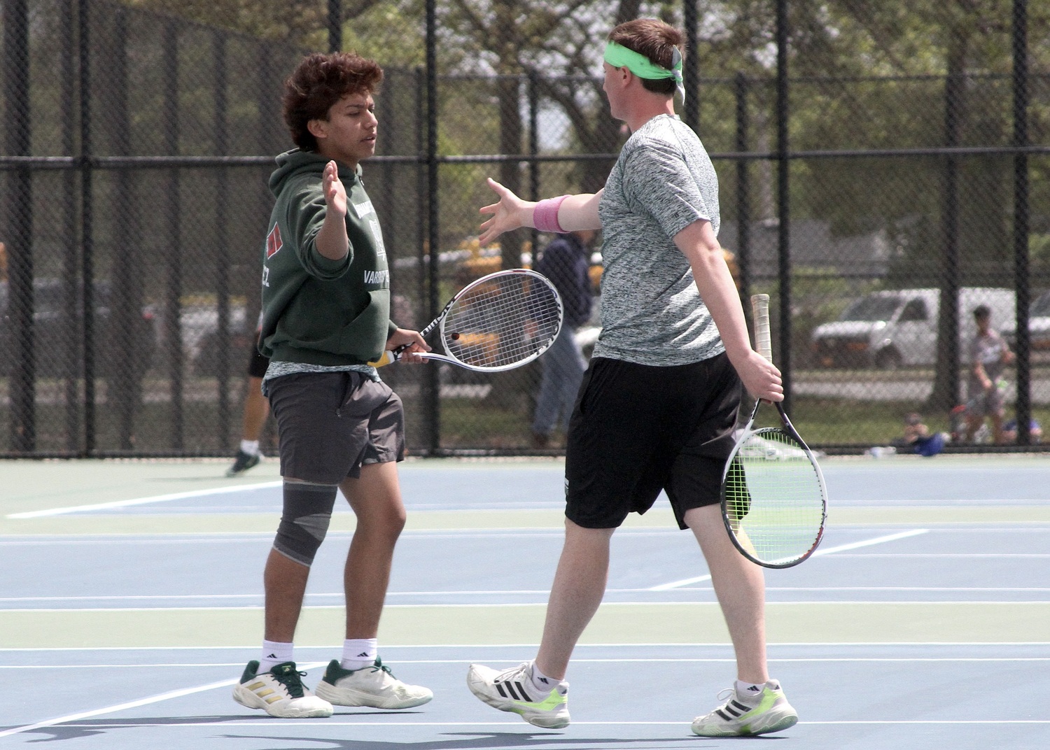 Sophomore Manny Gomez and senior Matt Moran celebrate a point. DESIRÉE KEEGAN